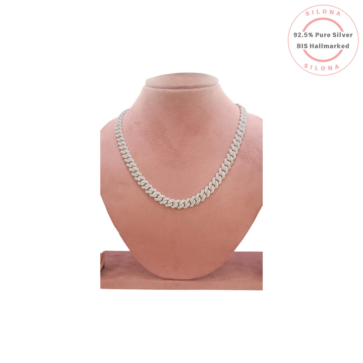 Silona's Iced Out Cuban Link Chain for men, crafted from 92.5 silver and set with Cubic Zirconia, displayed on a pink bust.