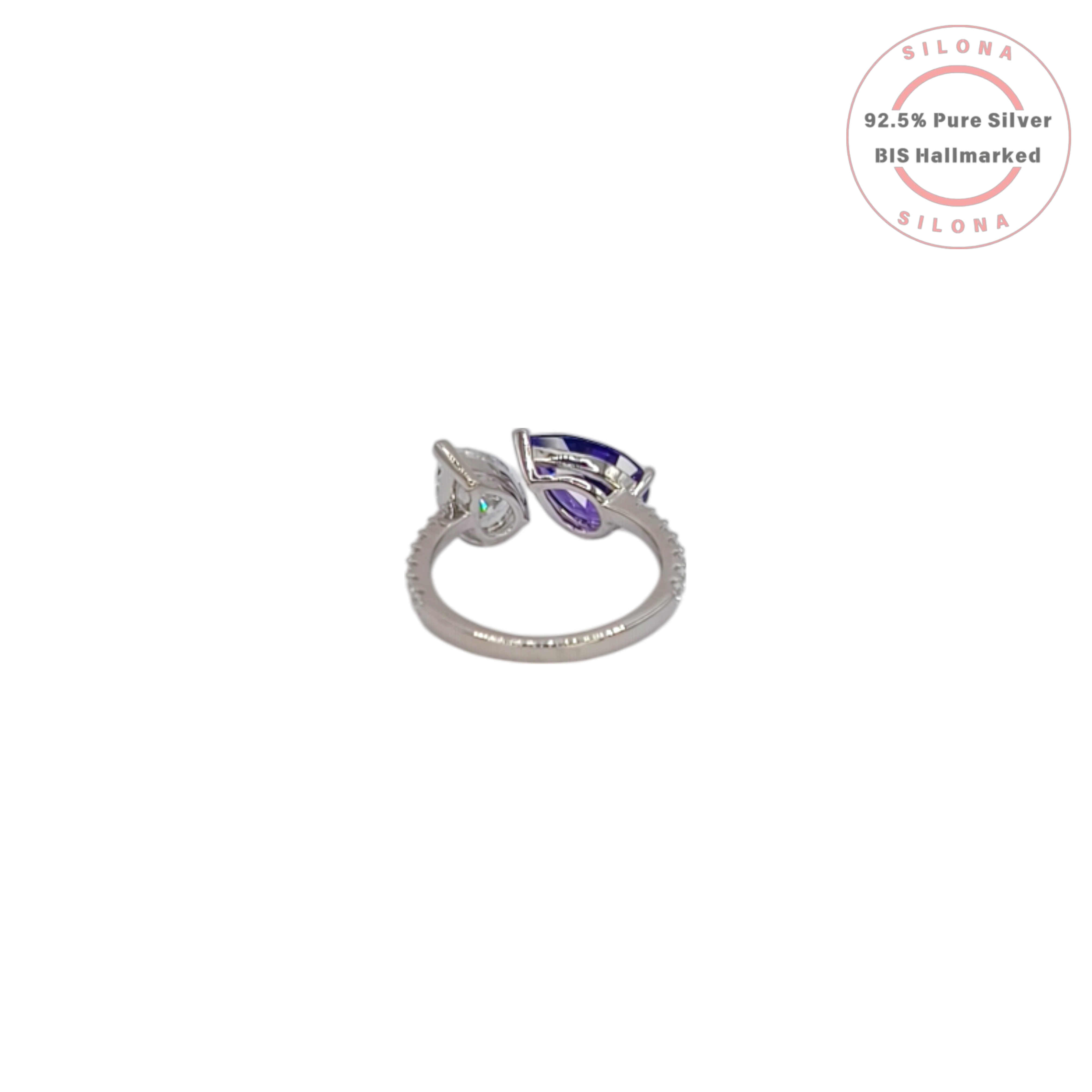 Silona's Toi et Moi ring featuring a pear-cut amethyst-hue cubic zirconia and a clear cubic zirconia, set in 92.5 sterling silver on a white background.