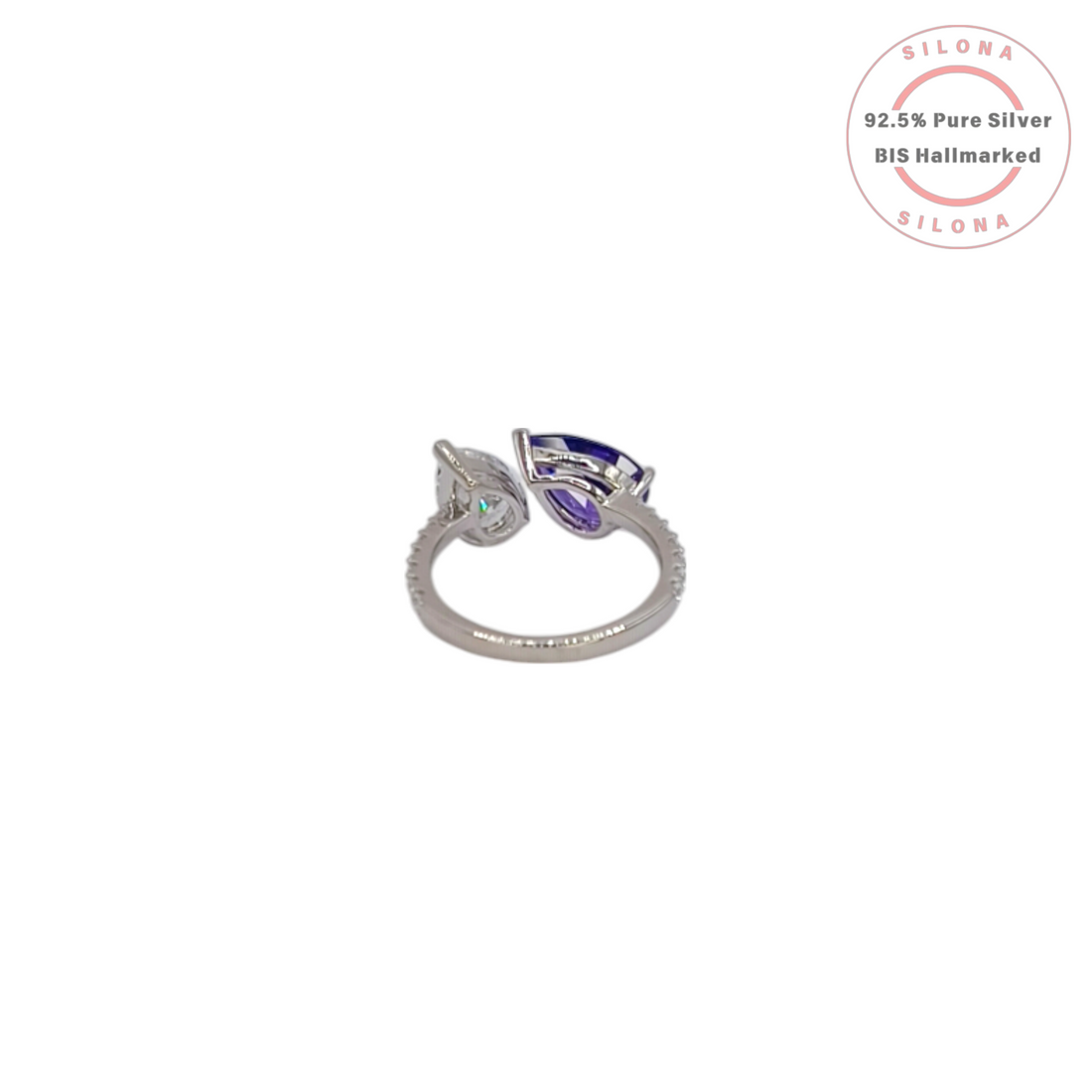 Silona's Toi et Moi ring featuring a pear-cut amethyst-hue cubic zirconia and a clear cubic zirconia, set in 92.5 sterling silver on a white background.