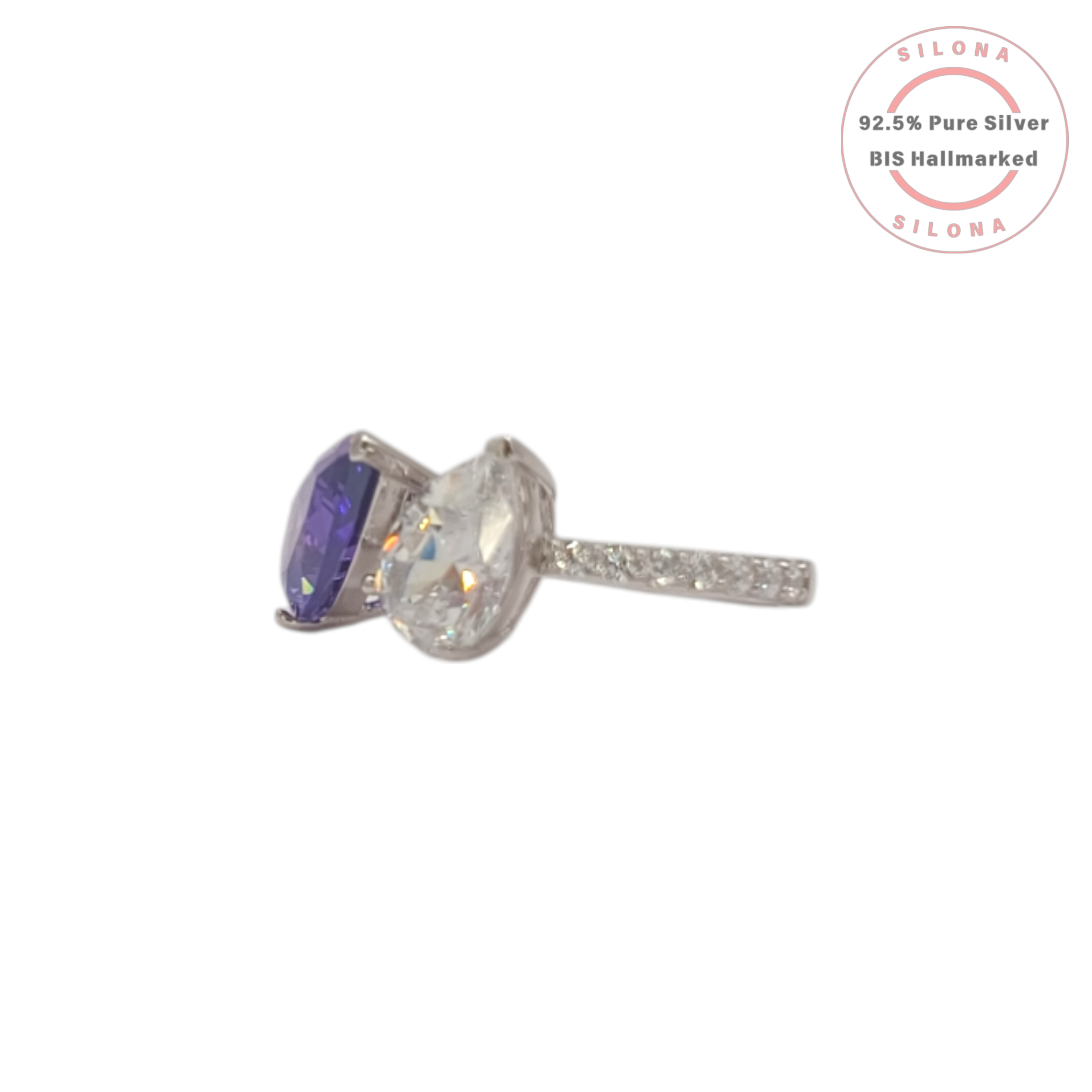 Silona's Toi et Moi ring featuring a pear-cut amethyst-hue cubic zirconia and a clear cubic zirconia, set in 92.5 sterling silver on a white background.