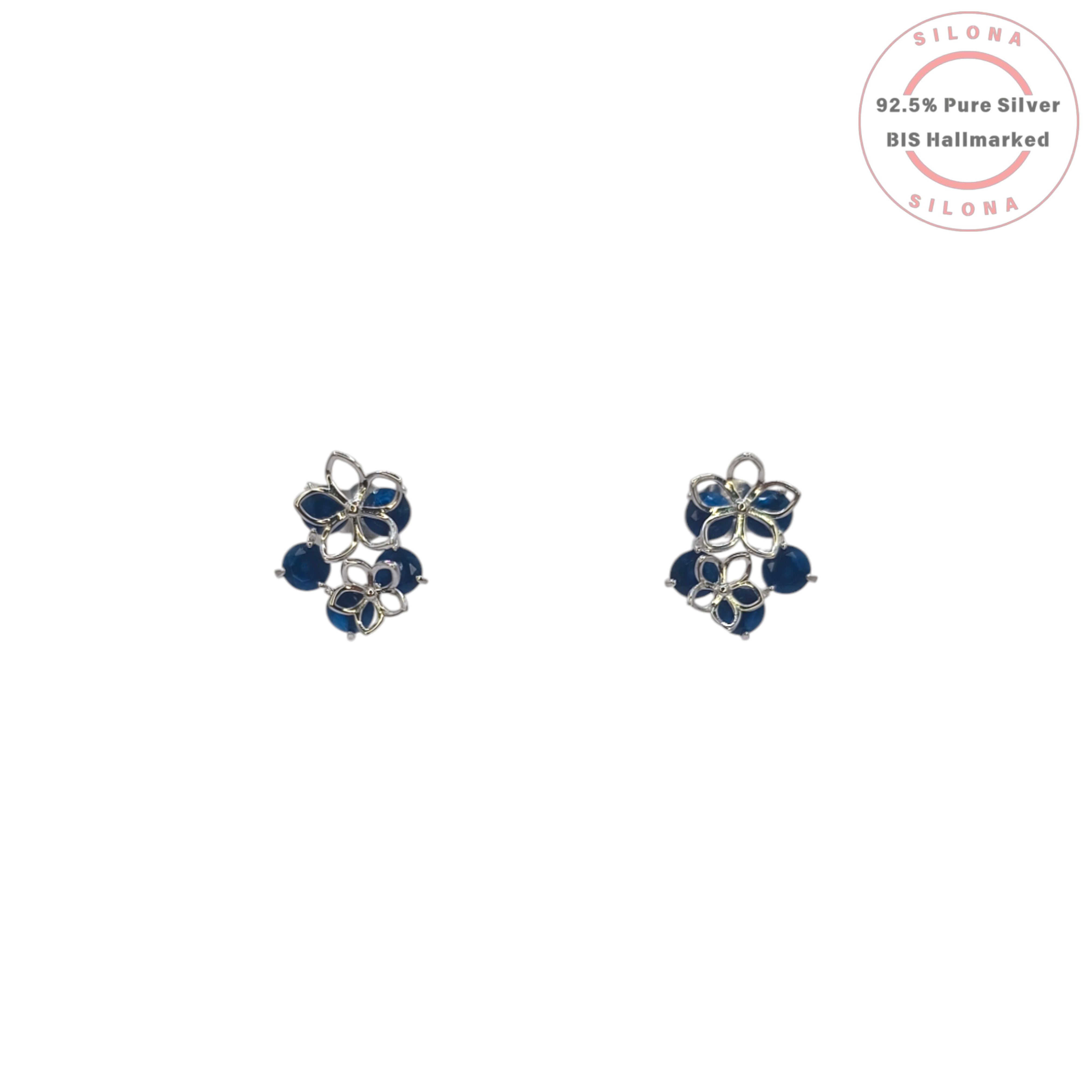 A pair of Silona's Floral Cluster Stud Earrings in 92.5 silver, featuring openwork petals and deep sapphire-blue stones, shown on a white background.