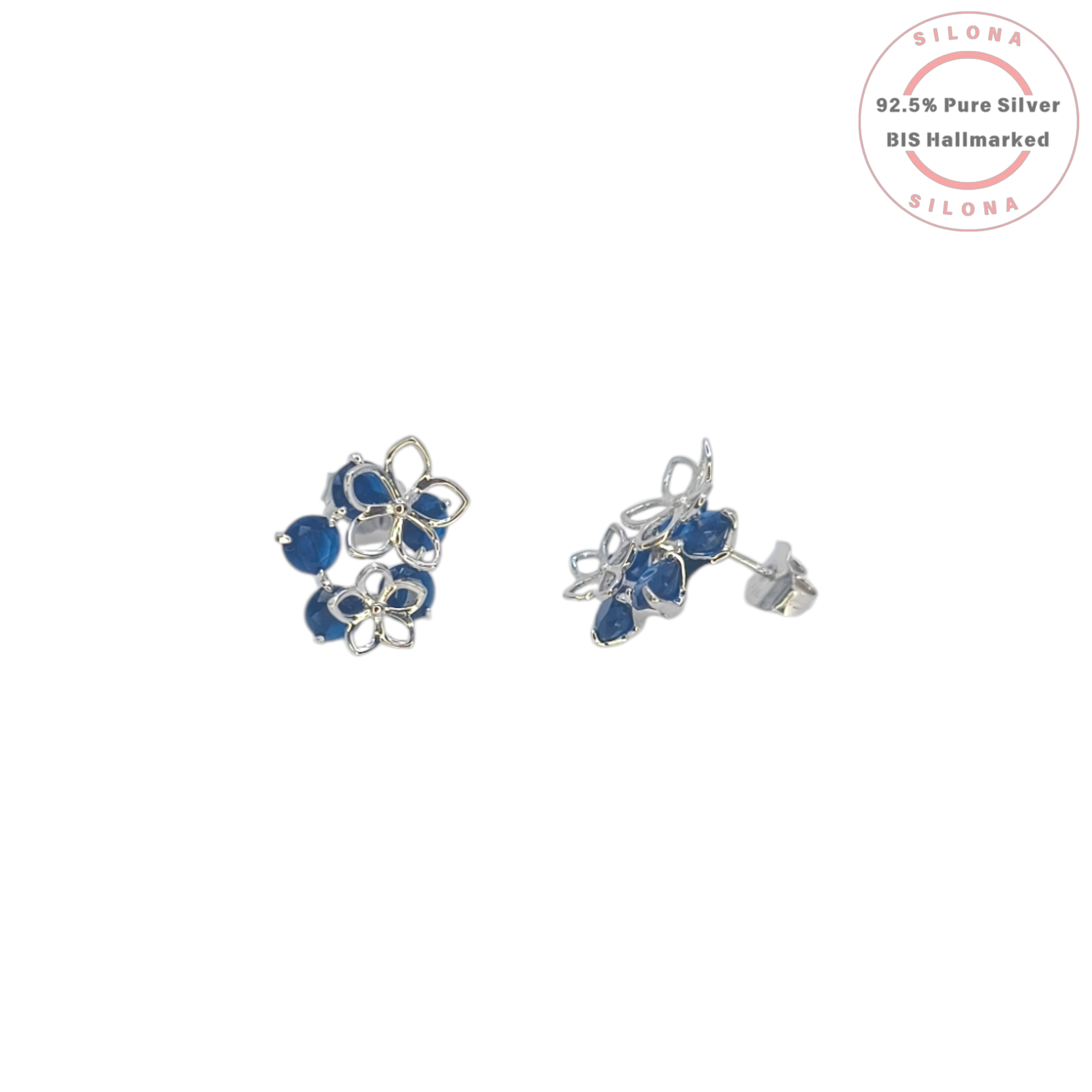 A pair of Silona's Floral Cluster Stud Earrings in 92.5 silver, featuring openwork petals and deep sapphire-blue stones, shown on a white background.