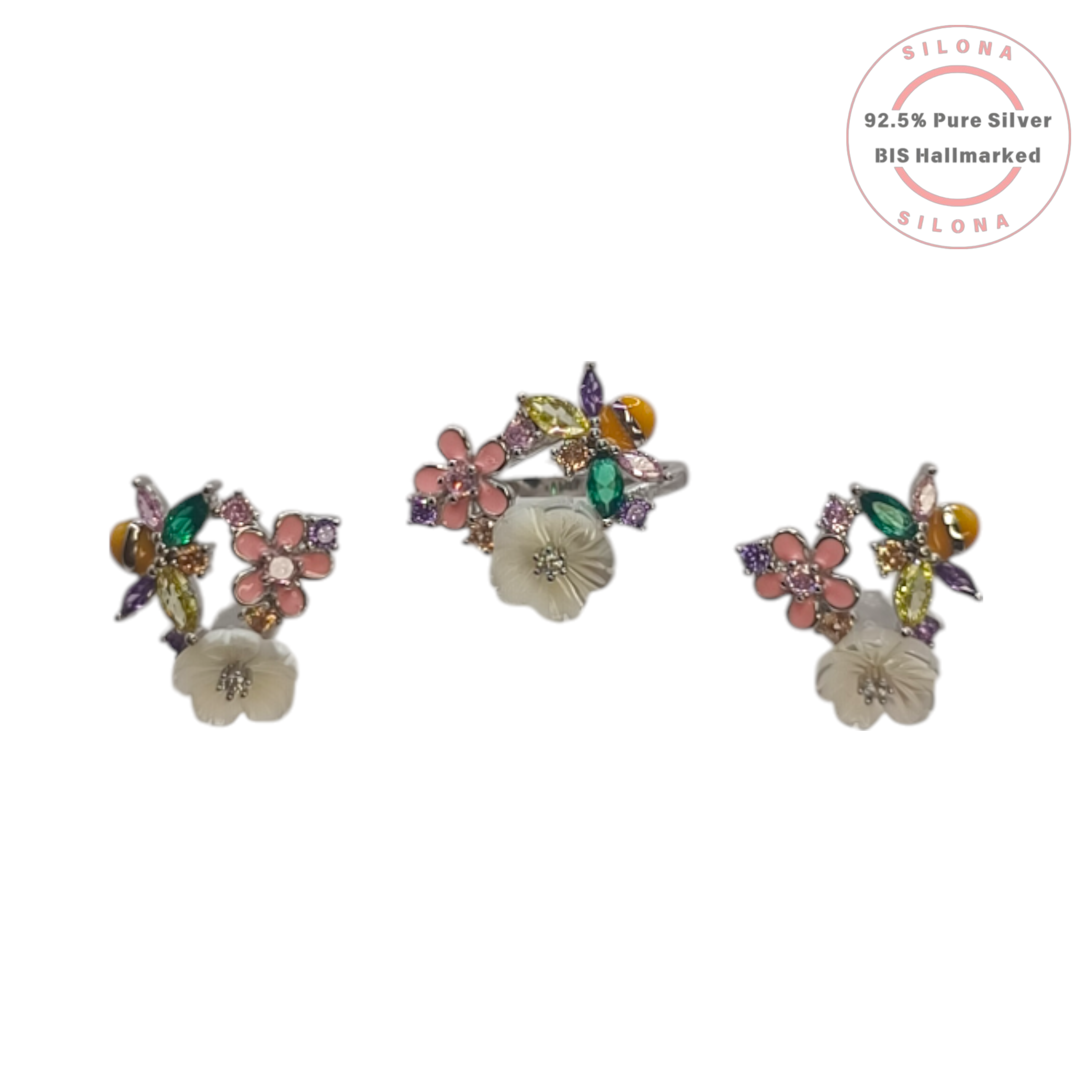 A floral jewellery set featuring a ring and two matching earrings with multi-colored stones, including a carved white flower and a pink enamel flower, on a white background with a Silona logo.