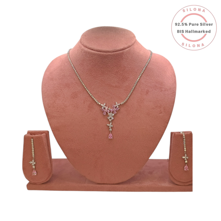 Silona's Elegant Pink Blossom Necklace and Earring Set, crafted in 92.5 silver with pink and white stones, displayed on a pink bust.