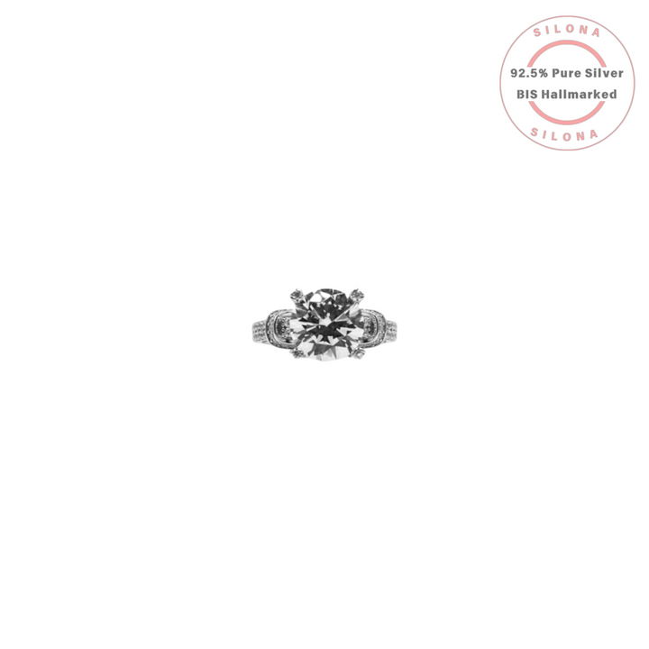 Ornate Statement Solitaire Ring in 92.5 Silver with a large brilliant-cut cubic zirconia and a pavé band on a white background.