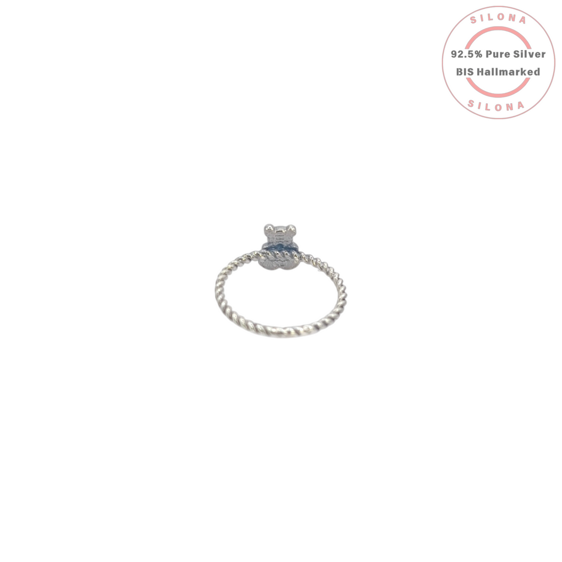 A whimsical teddy bear ring with a vibrant turquoise heart, crafted from 92.5 sterling silver with a twisted band design.