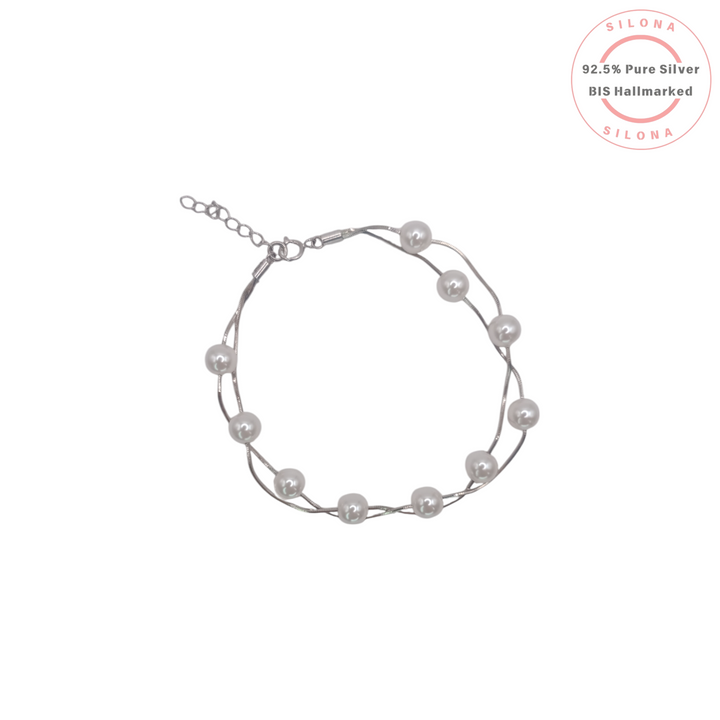 Elegant double strand silver snake chain bracelet with evenly spaced white pearls on a white background, featuring the Silona brand stamp.