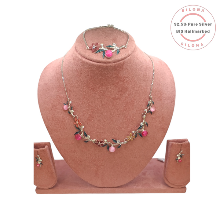 Silona Floral Vine necklace and earring set in 92.5 silver, displayed on a pink bust. The set features pink cat's-eye stones, colorful enamel flowers, and clear Cubic Zirconia.