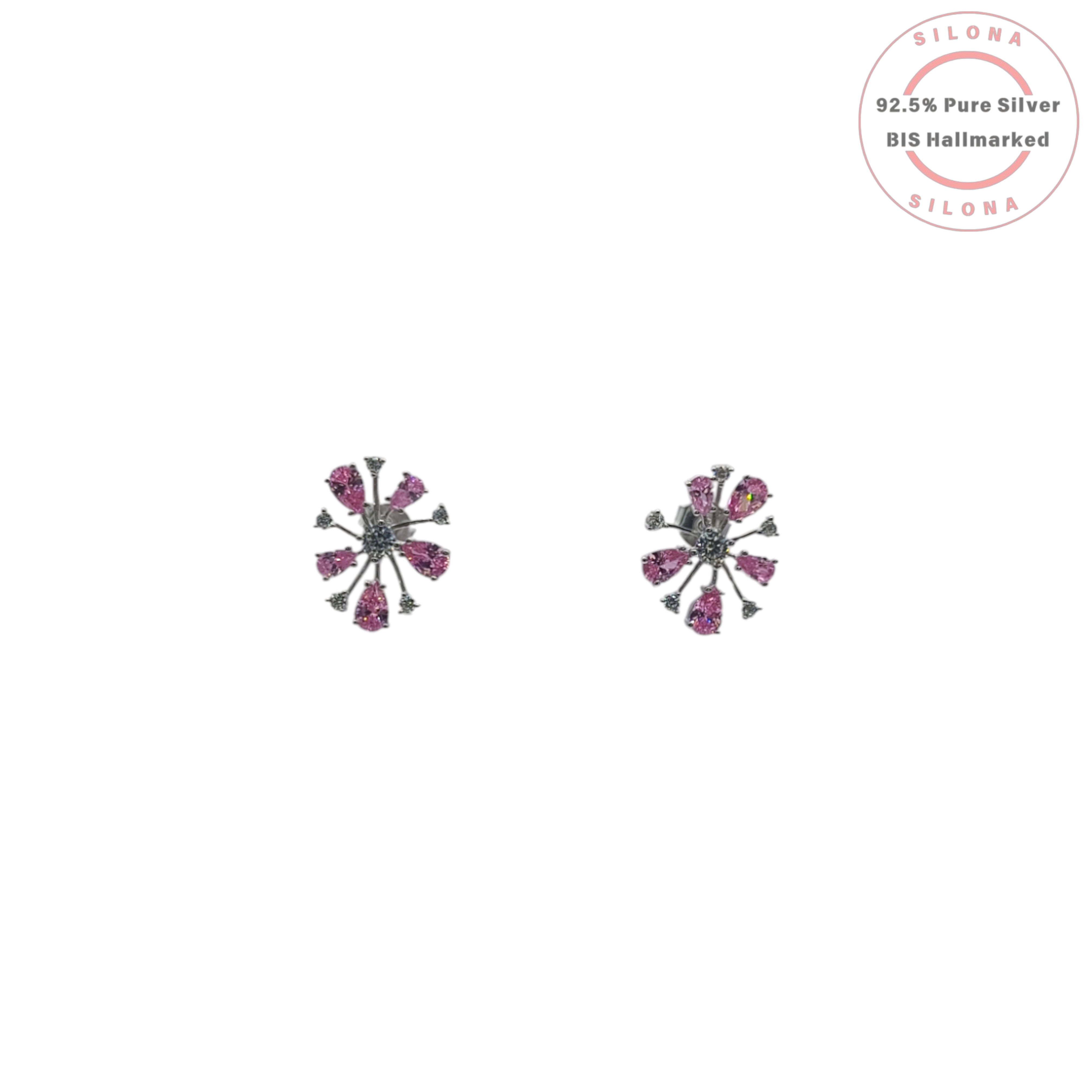 Pair of silver starburst stud earrings featuring pear-shaped pink cubic zirconia and small clear stones on a white background, with Silona brand hallmark.