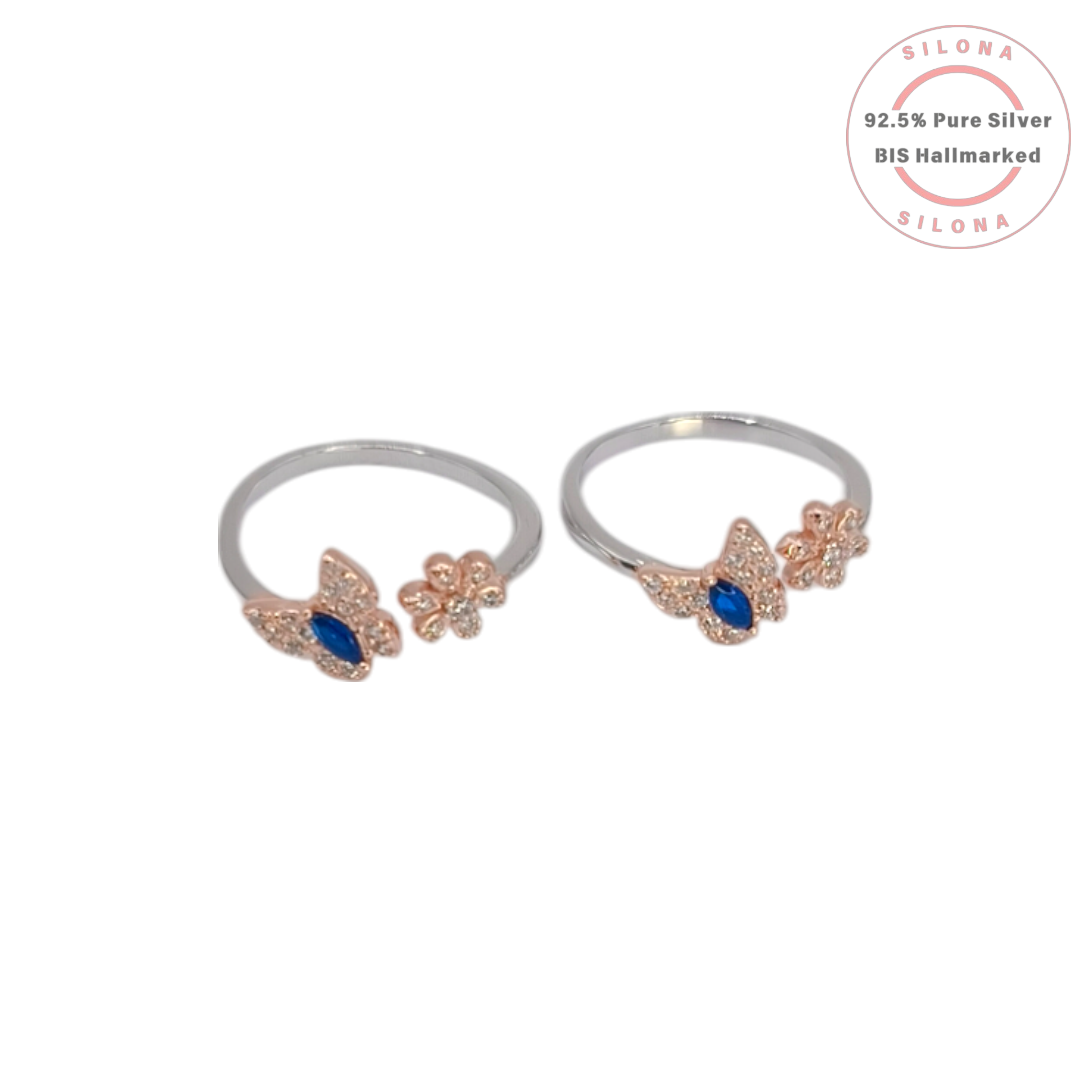 A pair of silver toe rings with a rose-gold plated butterfly and flower motif, featuring a central marquise-cut blue stone, shown on a white background with the Silona logo.