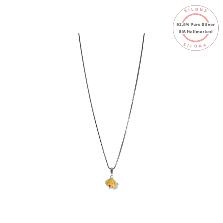 A silver box chain necklace with a small, playful puppy pendant with sunny yellow and white enamel.