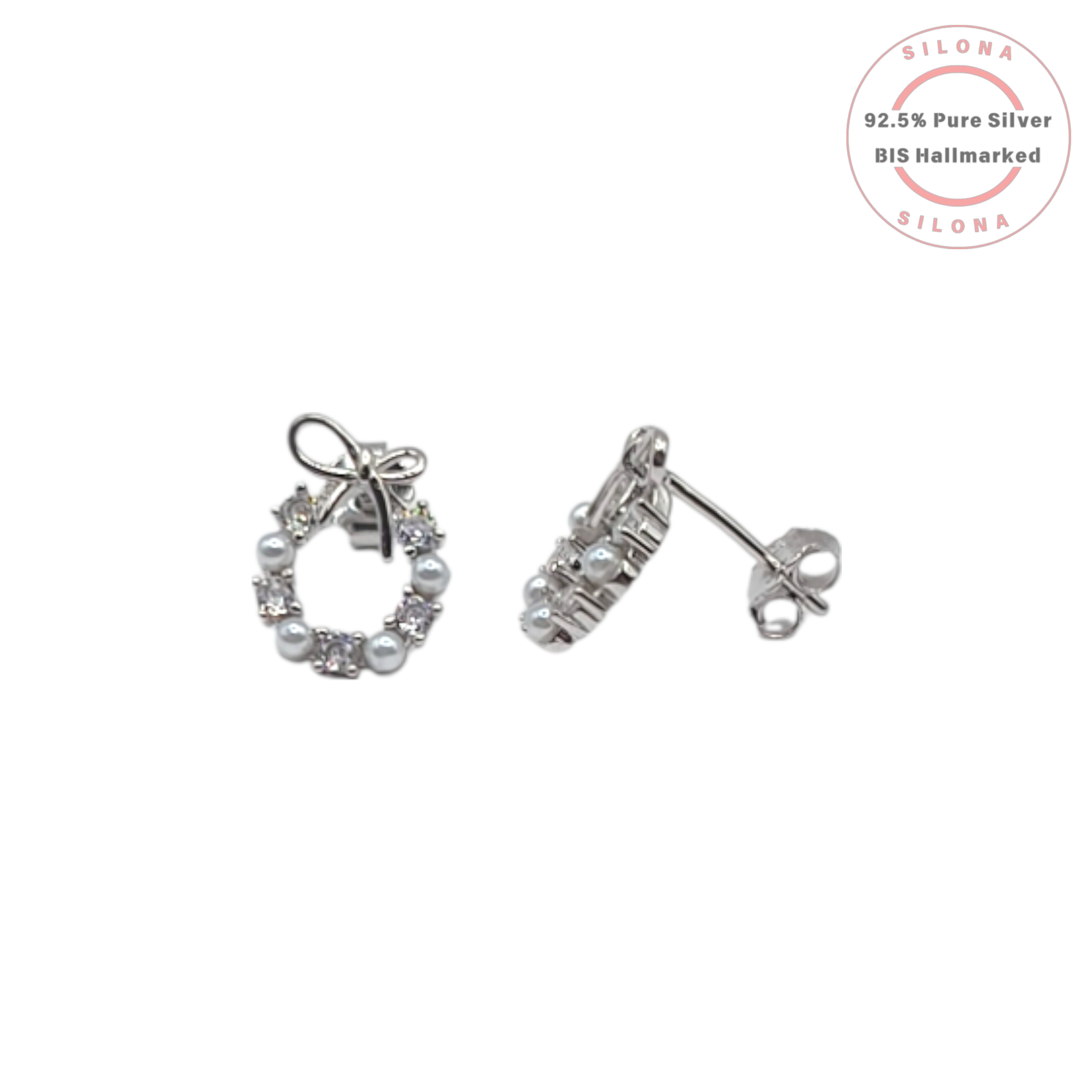 A pair of silver wreath stud earrings with alternating pearls and cubic zirconia, topped with a delicate silver bow, on a white background with a Silona hallmarking logo.