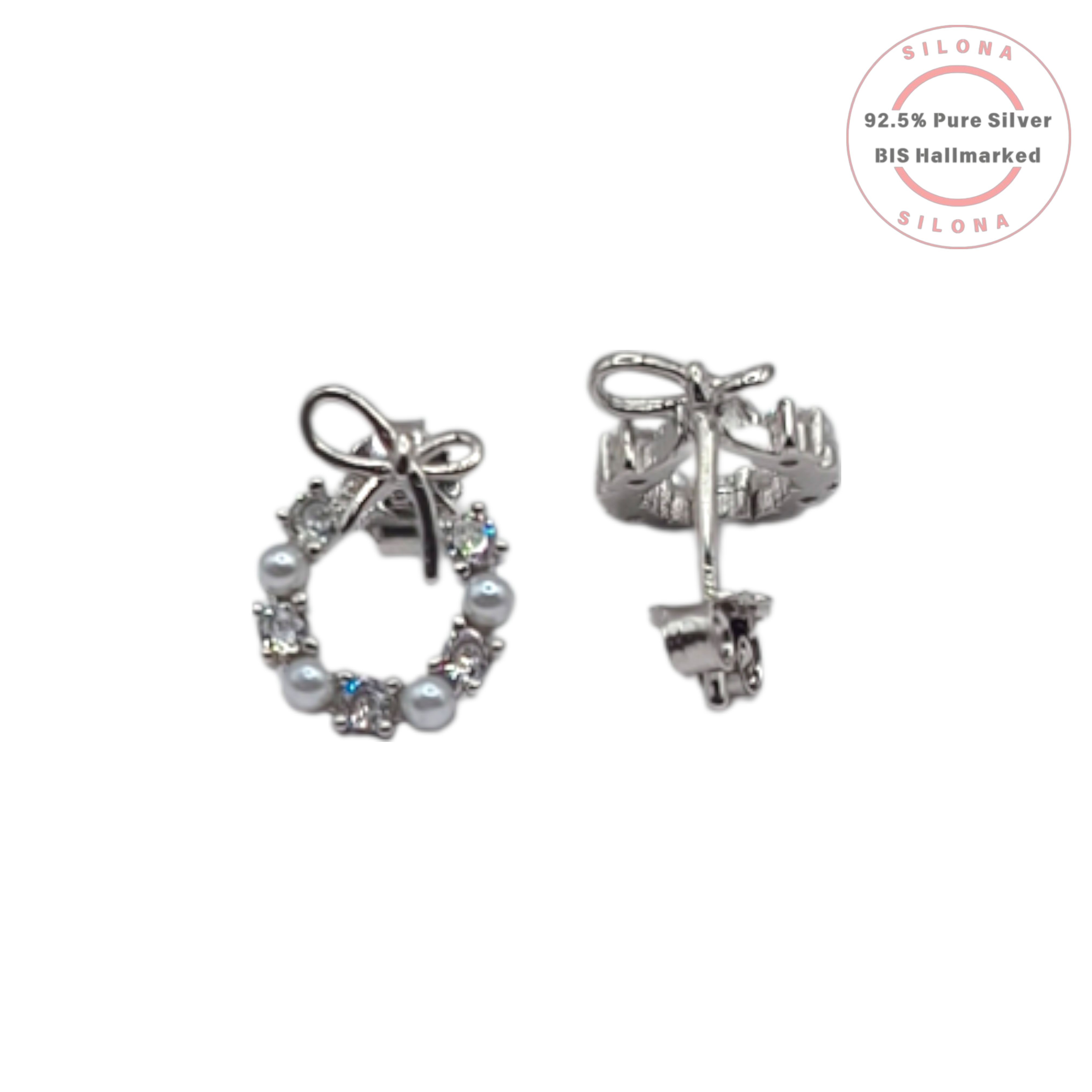 A pair of silver wreath stud earrings with alternating pearls and cubic zirconia, topped with a delicate silver bow, on a white background with a Silona hallmarking logo.