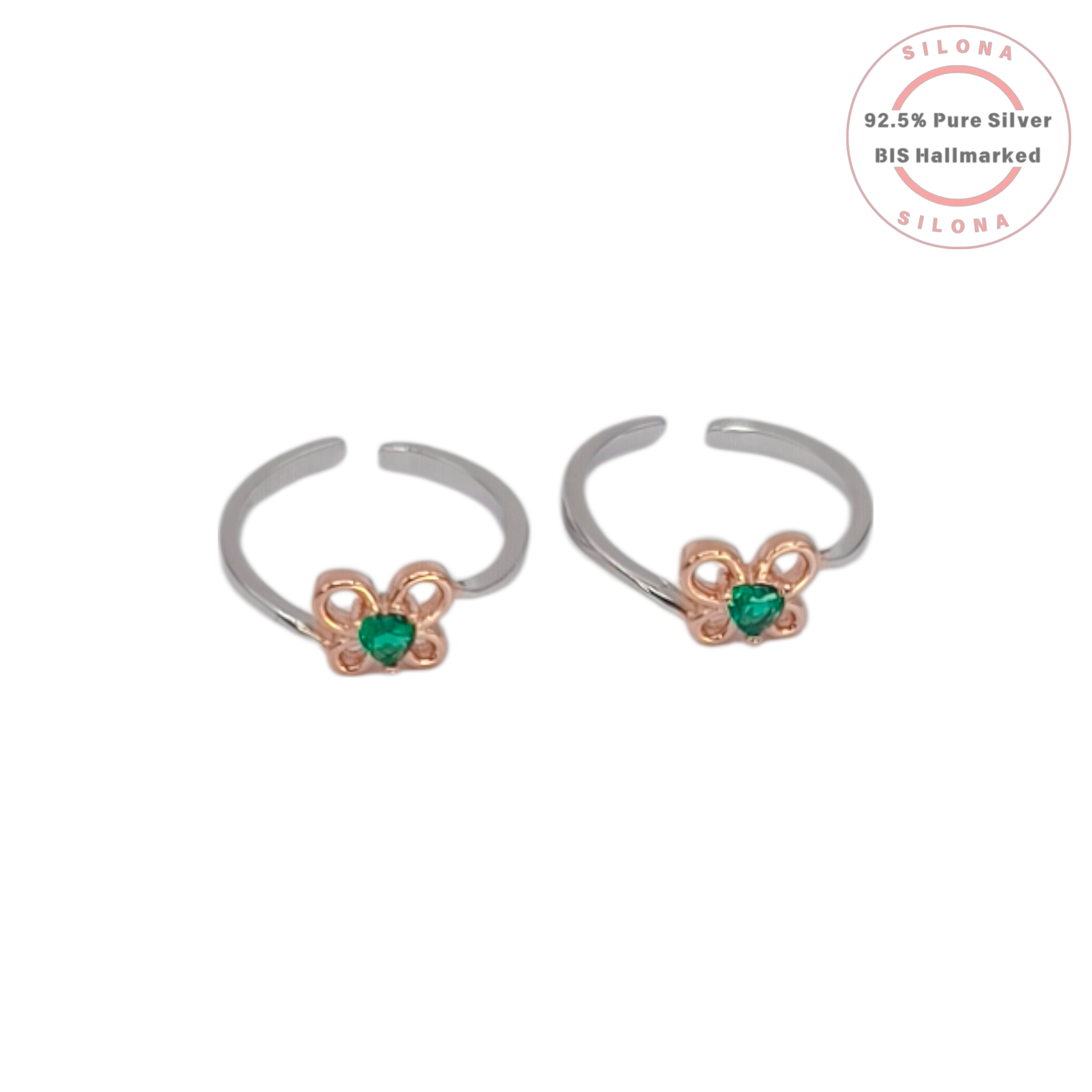 Pair of Silona dual-tone clover toe rings in 92.5 silver with a central emerald green heart-shaped stone, on a white background.