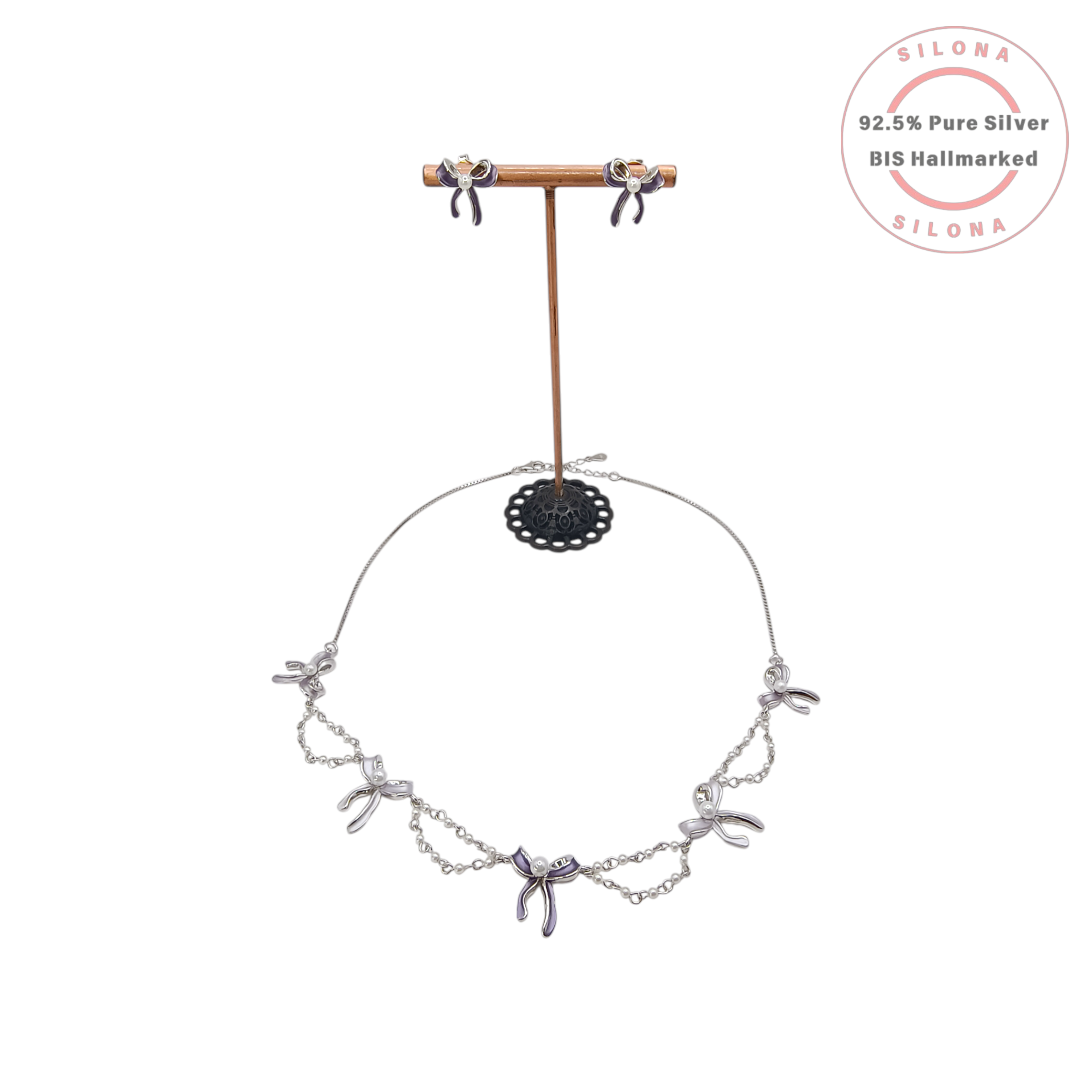 Silona's Chic Purple Bow Necklace and Earring Set in 92.5 Silver, featuring lavender enamel bows with pearl centers, on a white background.