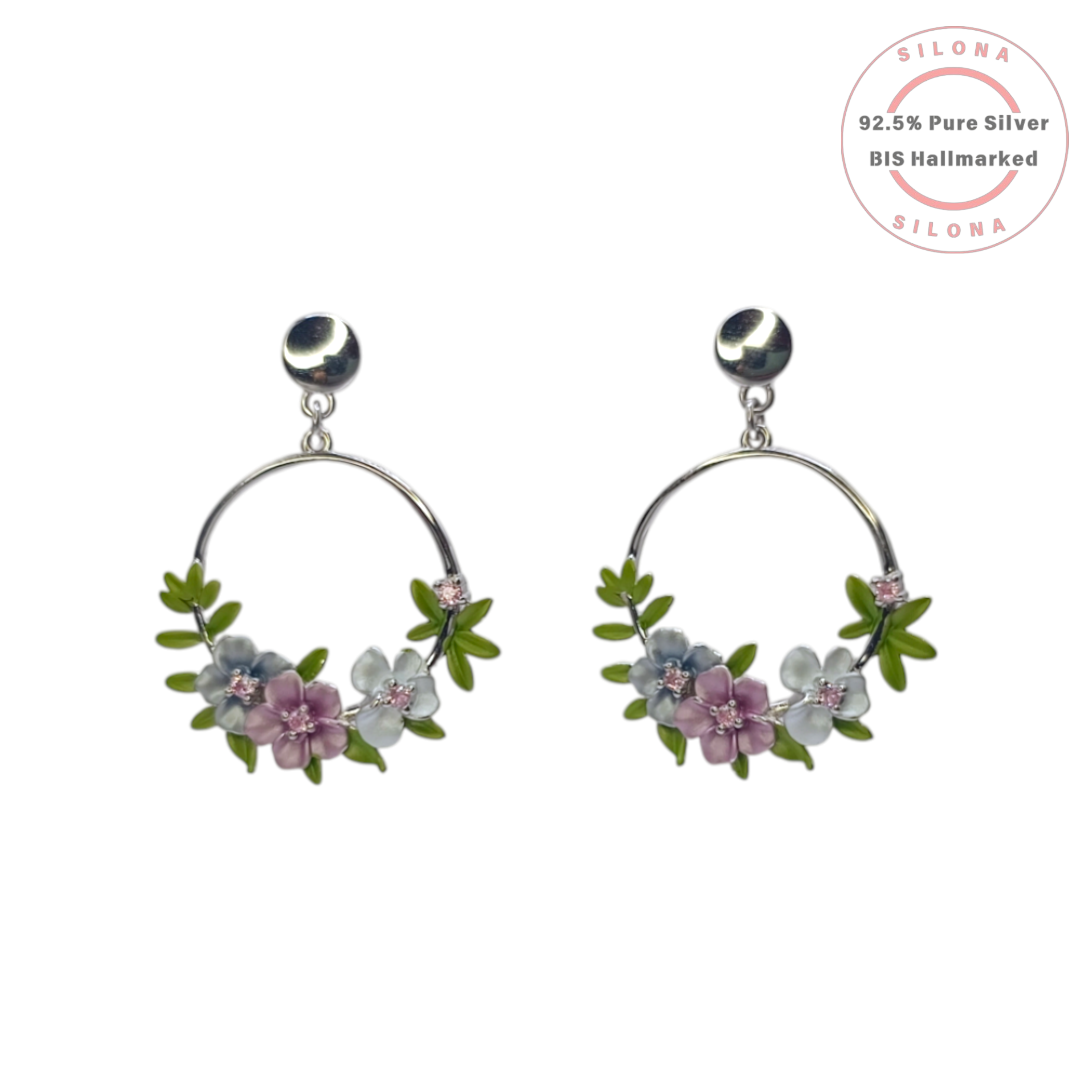 Pastel floral enamel necklace and matching hoop earrings set in 92.5 silver, displayed on a stand against a white background.