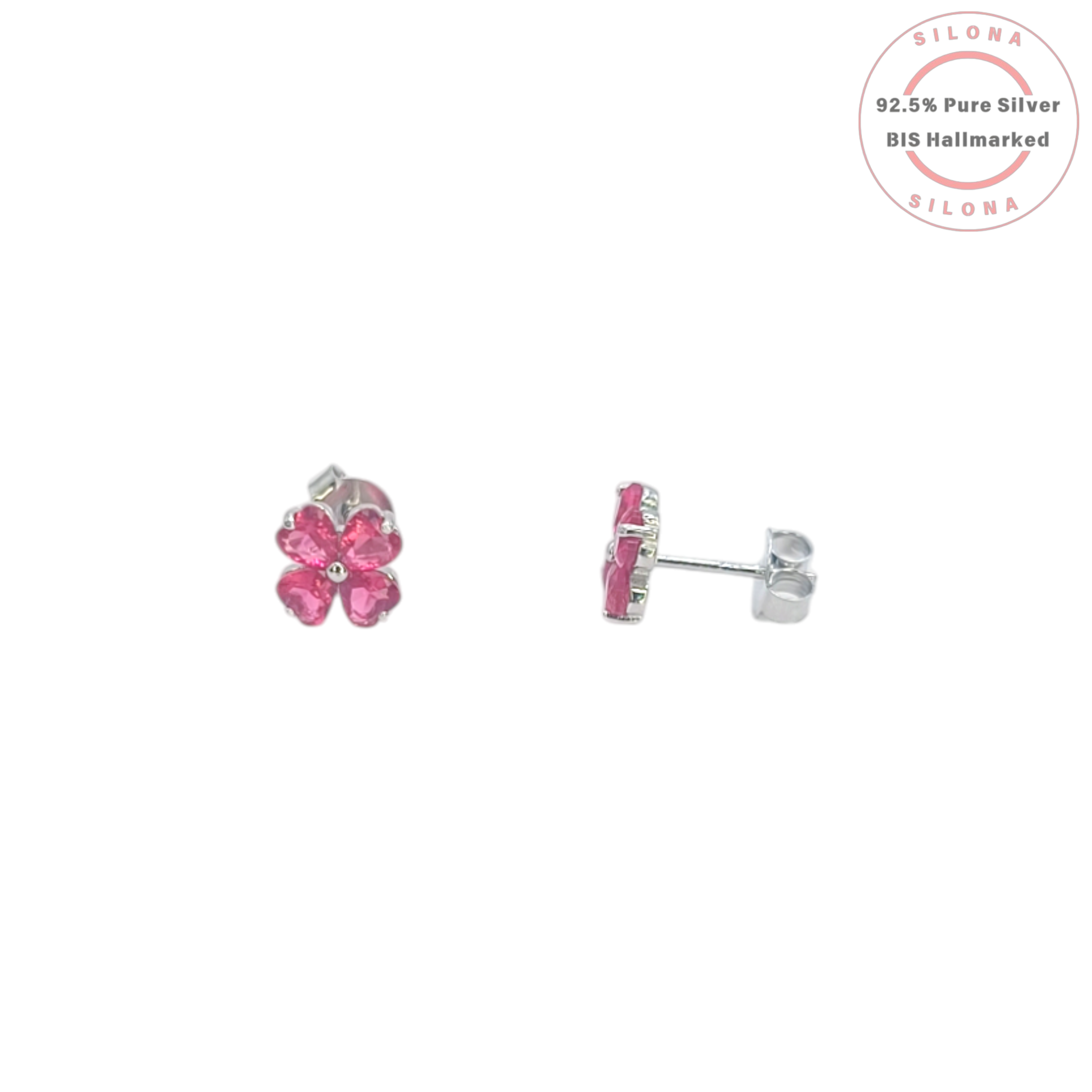 A pair of Silona silver stud earrings shaped like four-leaf clovers with vibrant pink heart-shaped stones on a white background.