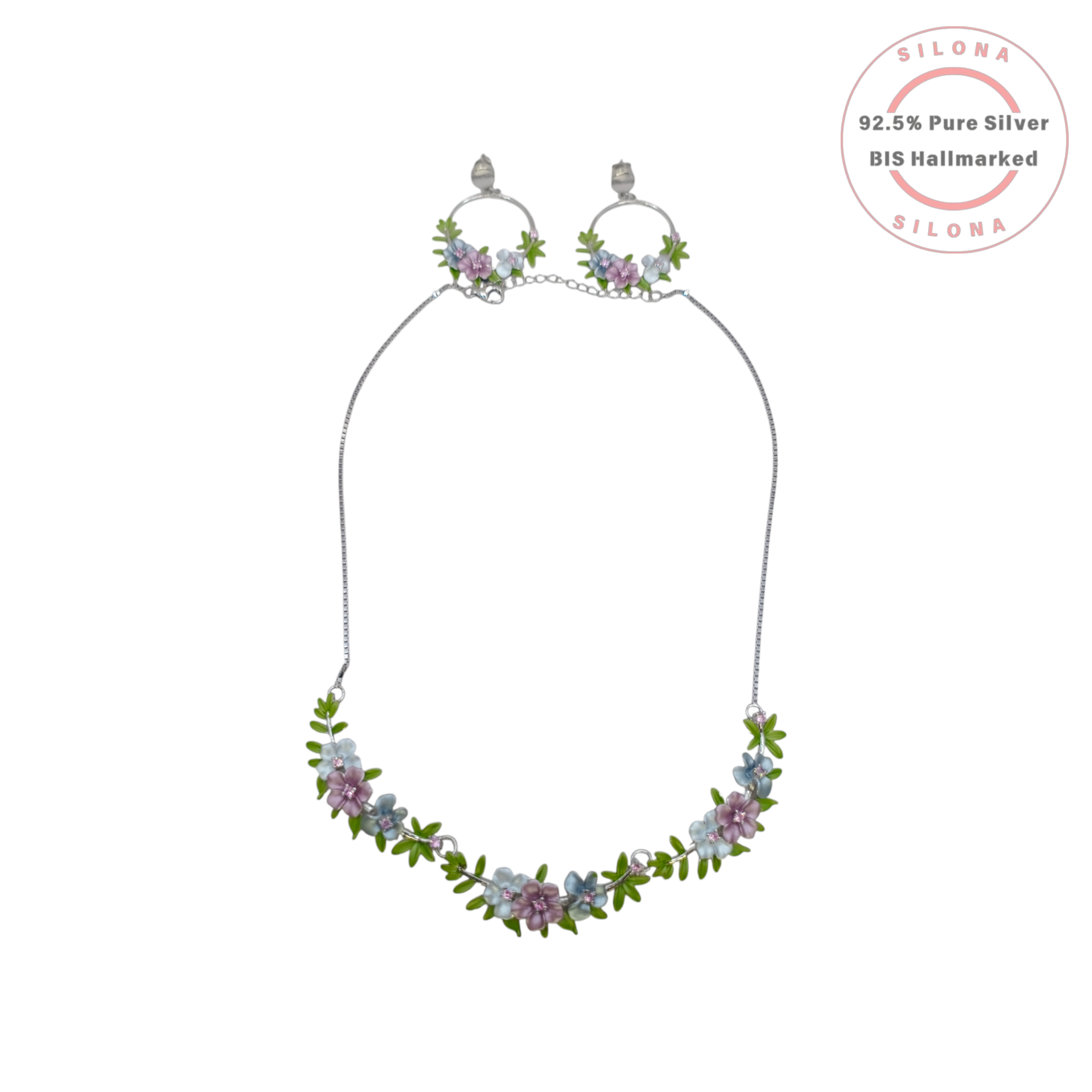 Pastel floral enamel necklace and matching hoop earrings set in 92.5 silver, displayed on a stand against a white background.