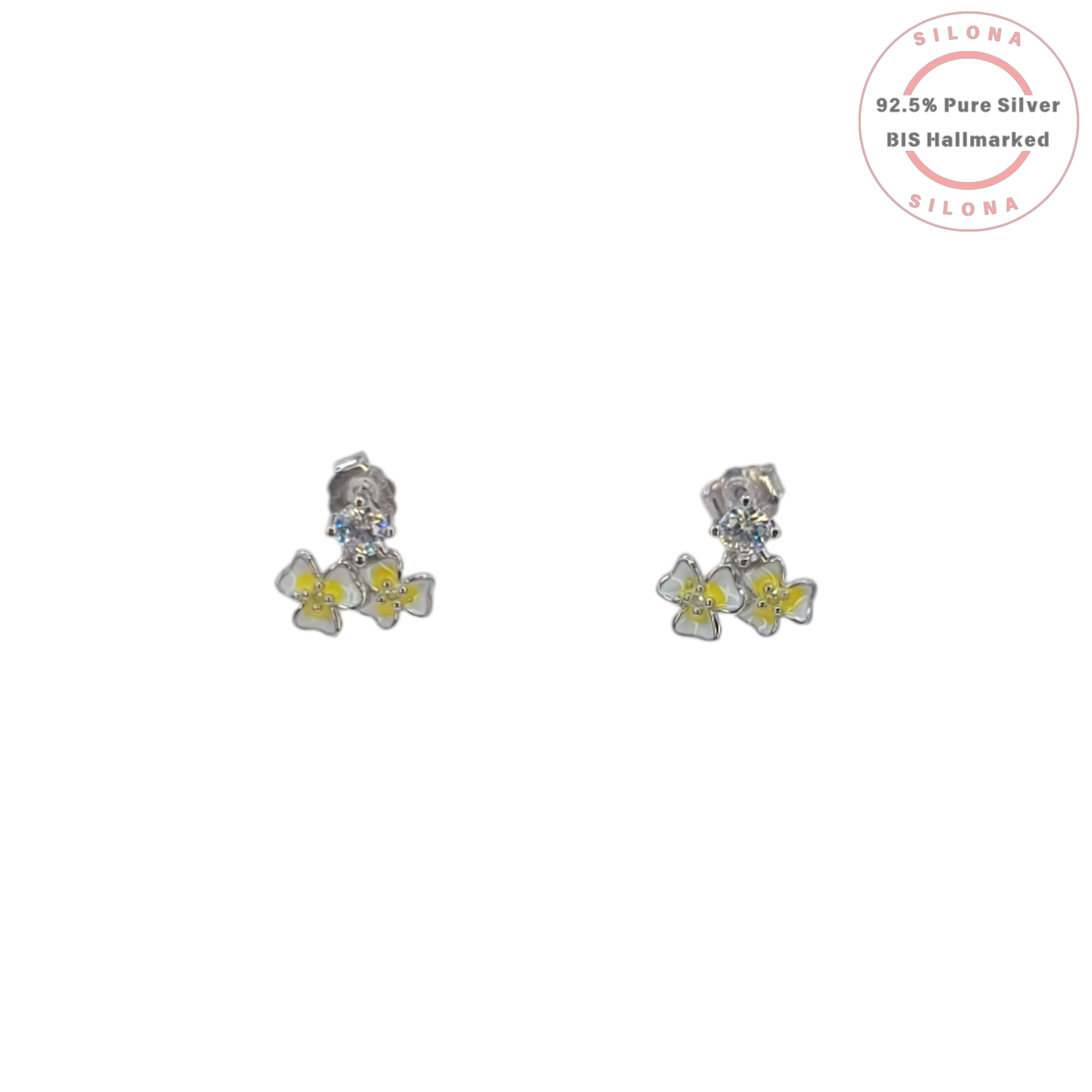 Pair of Silona silver stud earrings featuring a solitaire stone and a dangling cluster of two white and yellow enamel frangipani flowers on a white background.