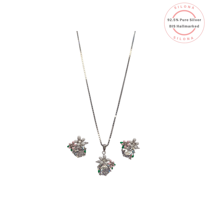 Silona's Pastel Bloom Floral Necklace and Earring Set in 92.5 silver, featuring solitaire stones with white, pink, and green enamel flower details on a silver box chain.