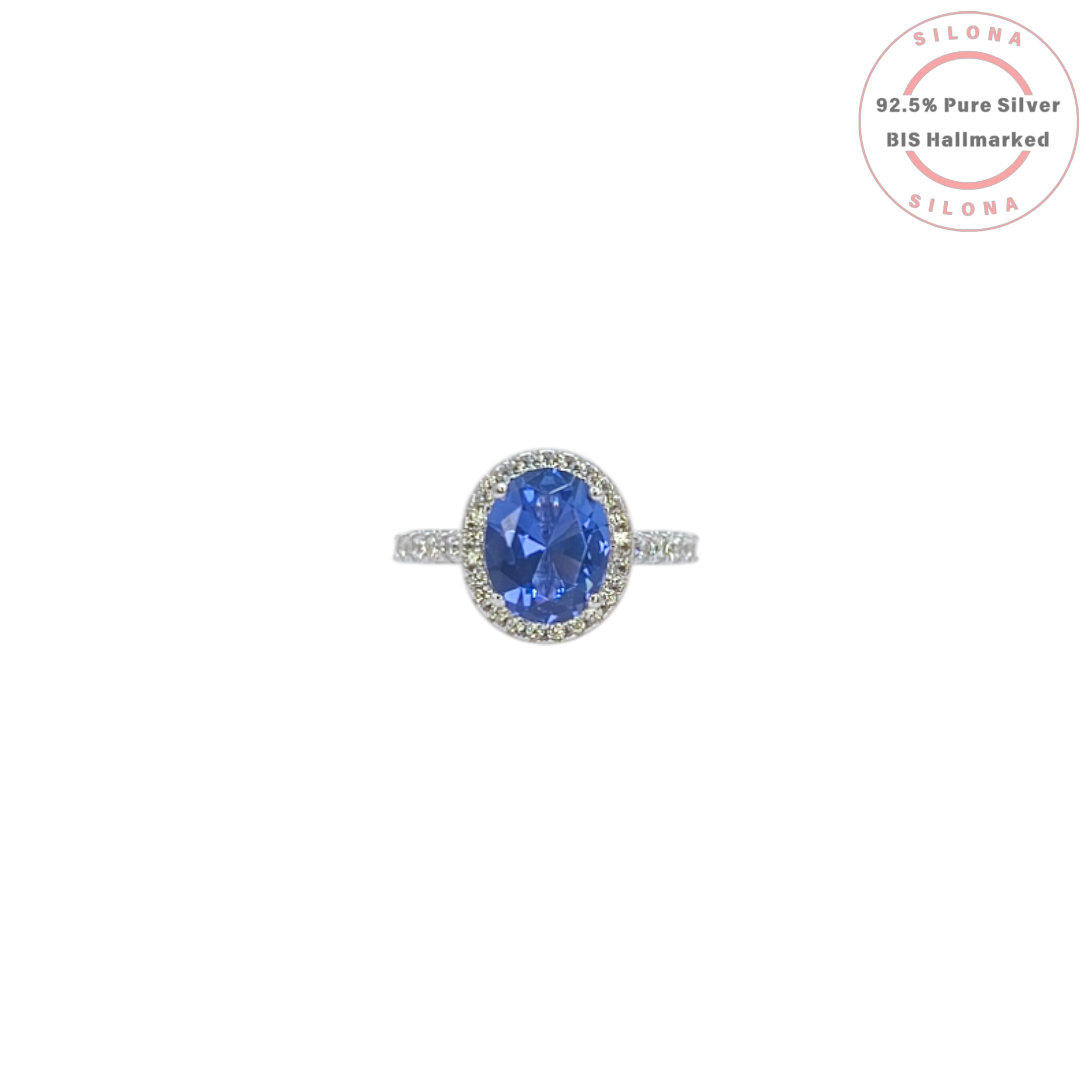 Front view of the Heirloom Tanzanite-Hue Halo Ring, showcasing the large oval blue stone, a sparkling pavé halo, and a studded 92.5 silver band on a white background.