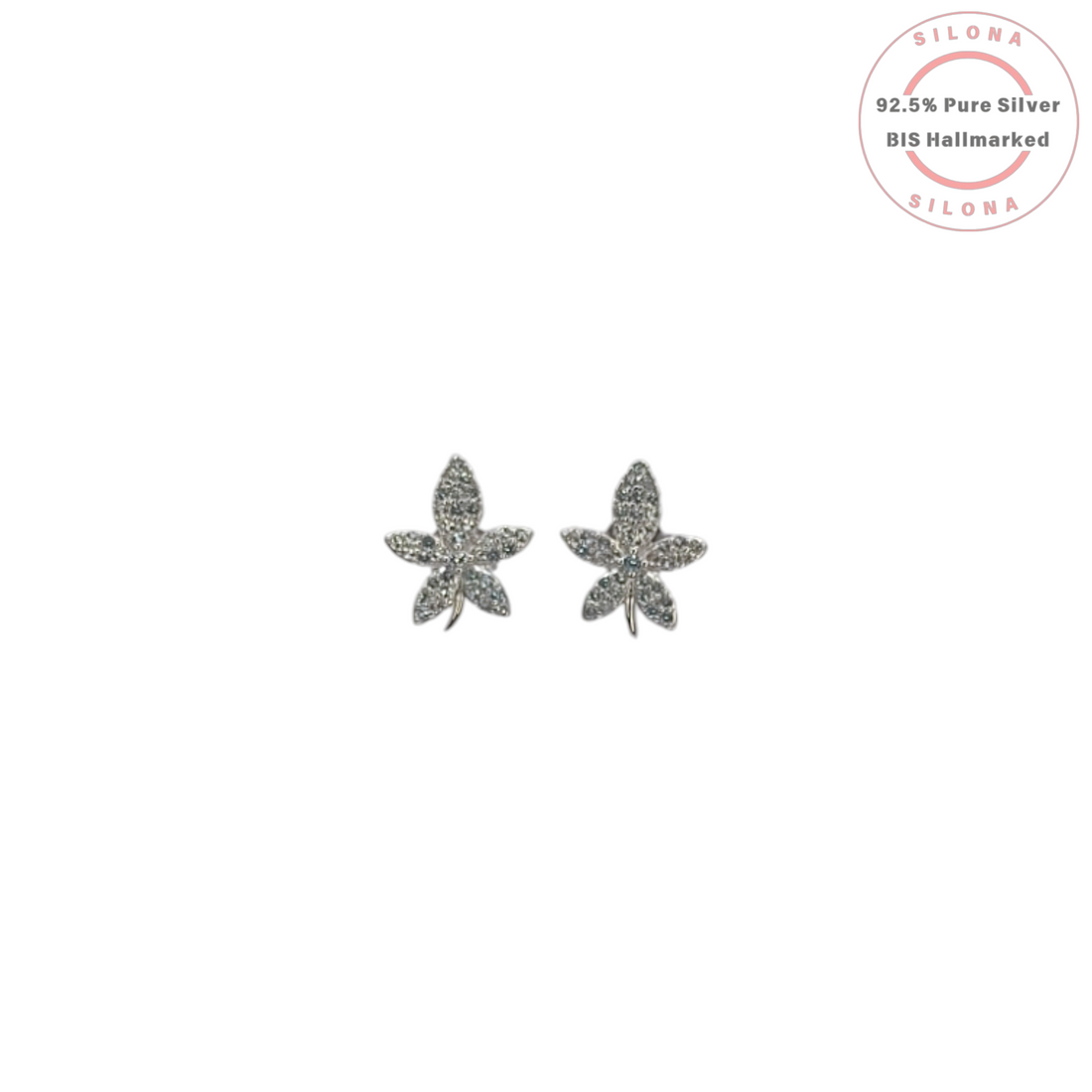 A pair of silver floral stud earrings, fully paved with sparkling cubic zirconia, on a white background.