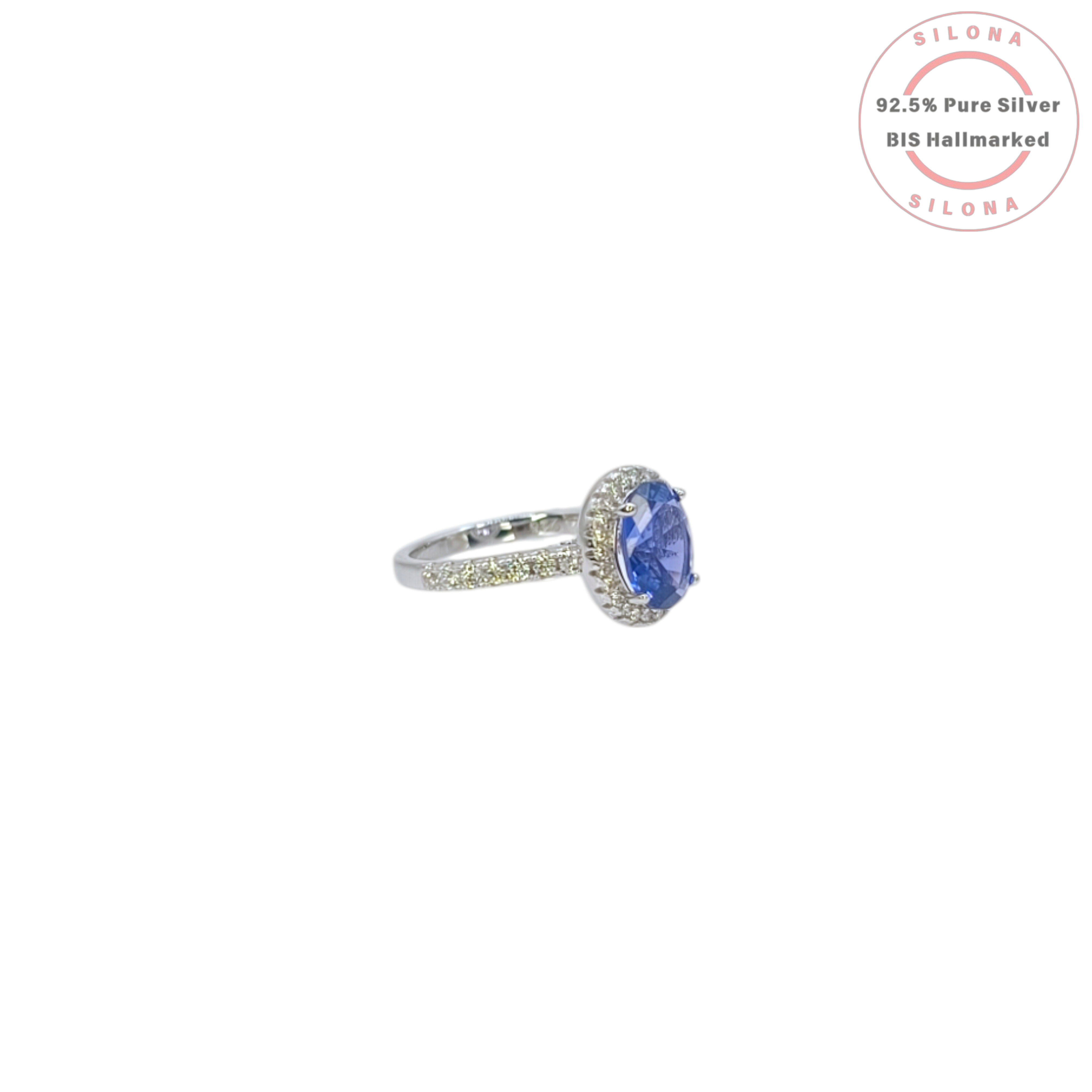 Front view of the Heirloom Tanzanite-Hue Halo Ring, showcasing the large oval blue stone, a sparkling pavé halo, and a studded 92.5 silver band on a white background.