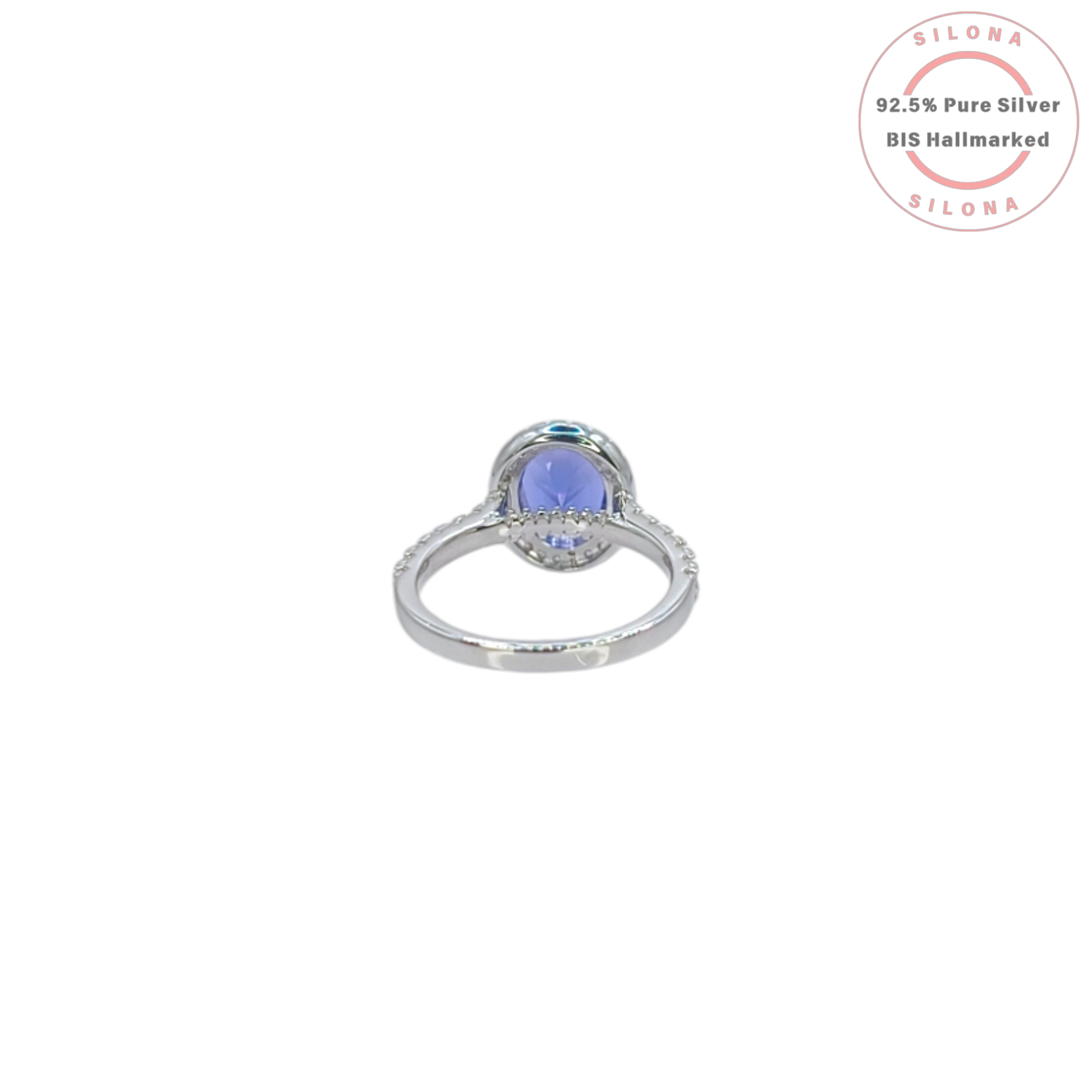 Front view of the Heirloom Tanzanite-Hue Halo Ring, showcasing the large oval blue stone, a sparkling pavé halo, and a studded 92.5 silver band on a white background.
