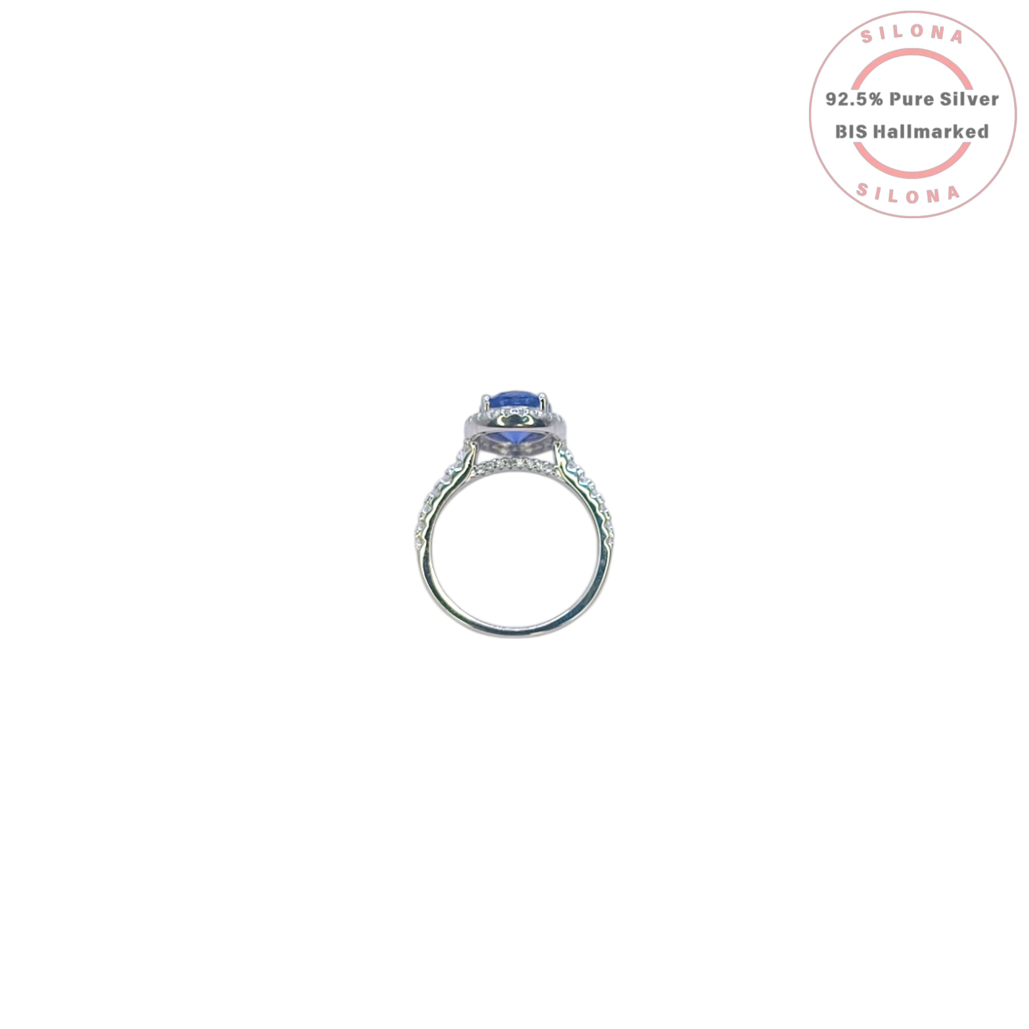 Front view of the Heirloom Tanzanite-Hue Halo Ring, showcasing the large oval blue stone, a sparkling pavé halo, and a studded 92.5 silver band on a white background.