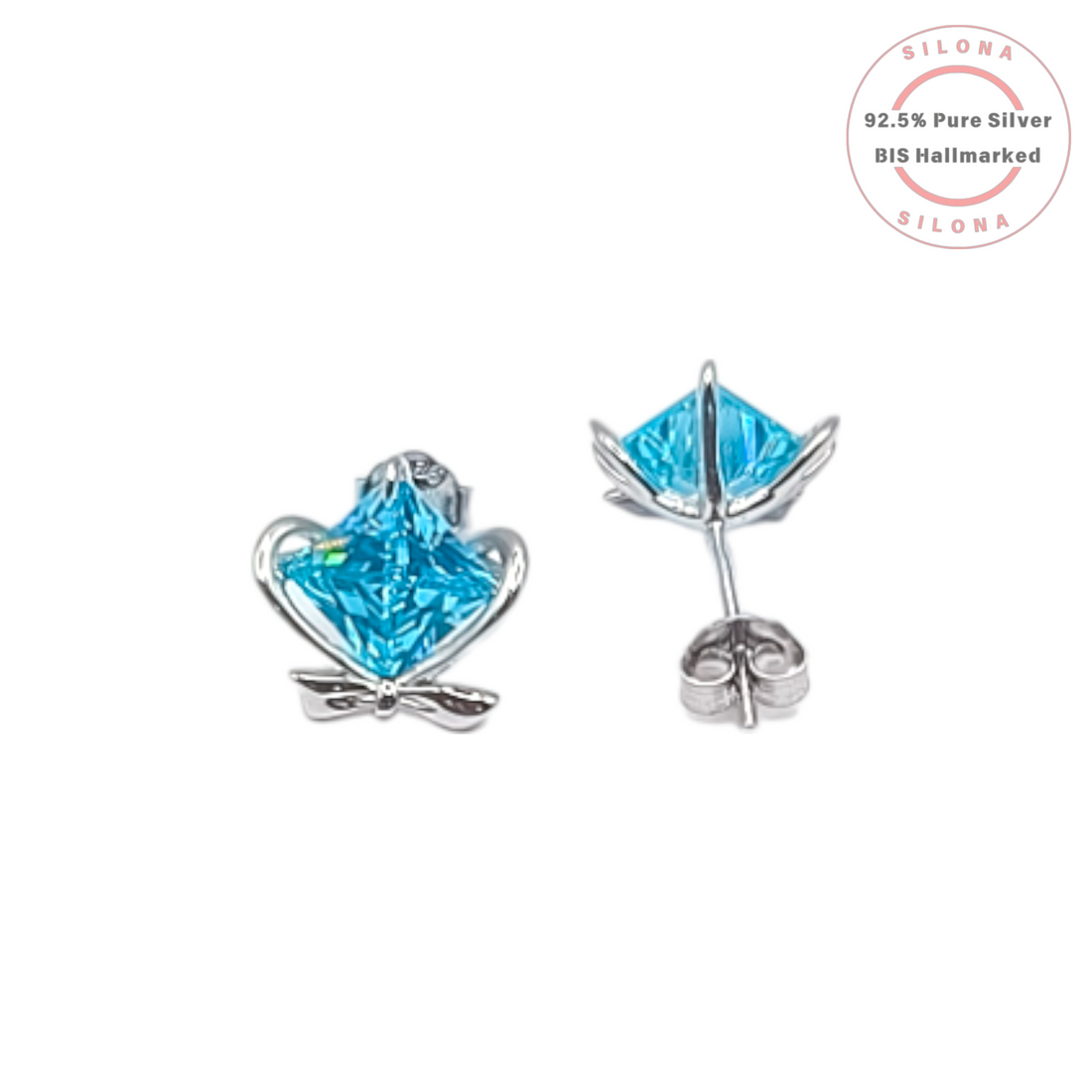 A pair of sterling silver stud earrings featuring a princess-cut, aqua blue cubic zirconia stone set within a delicate heart and bow design, on a white background.