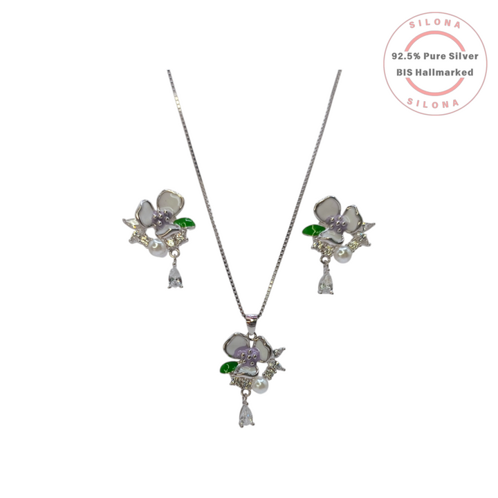 Silona Enamel Pansy Necklace and Earring Set in 92.5 Silver, featuring lavender and white enamel, pearls, and teardrop CZ stones on a white background.
