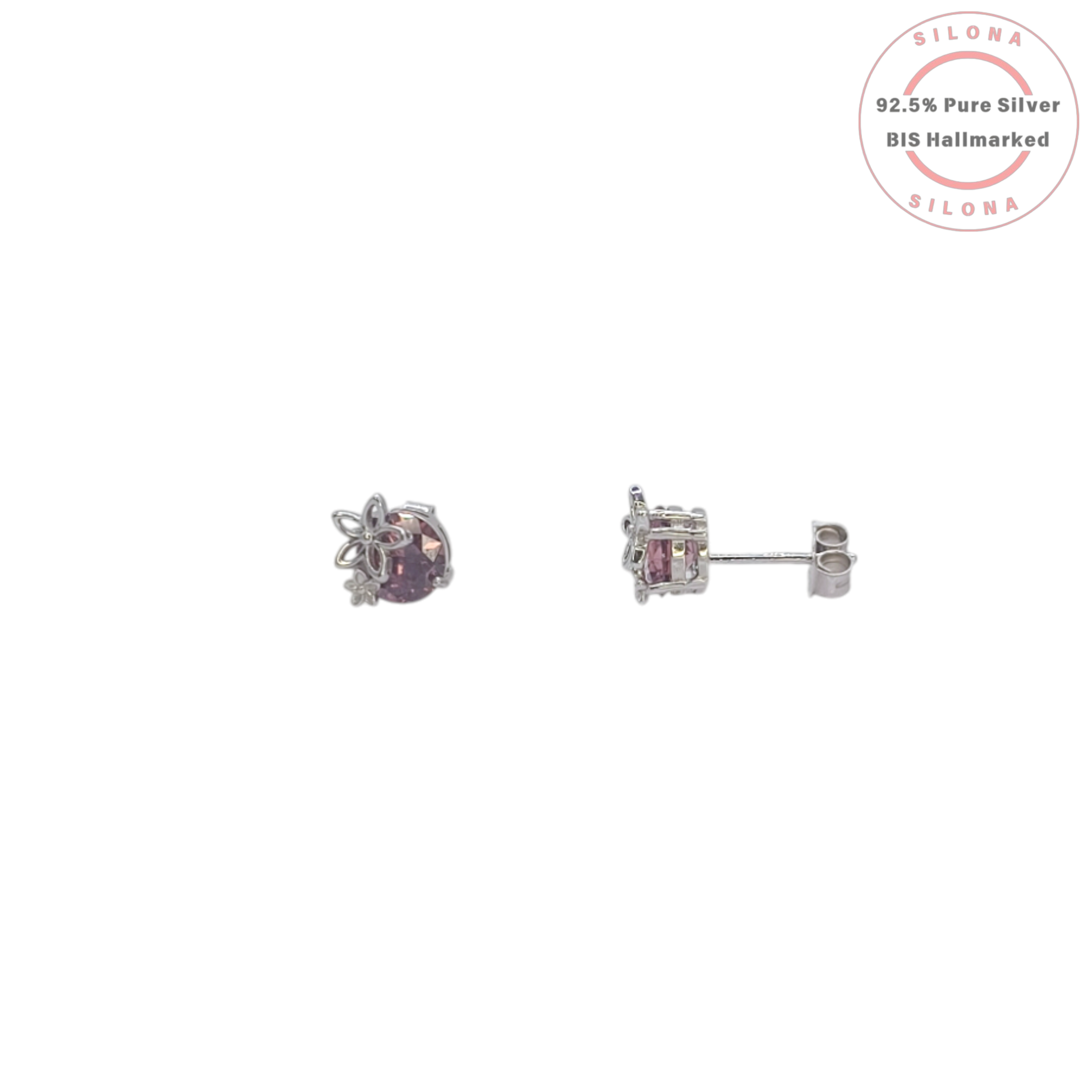 A pair of silver stud earrings featuring a round, sparkling plum-colored stone, each adorned with a silver floral motif on top, against a white background.