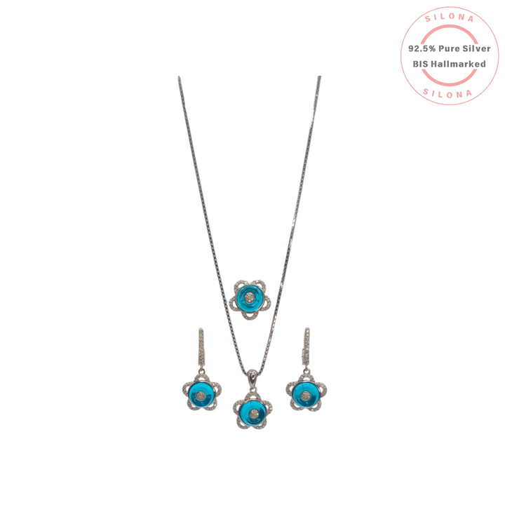 Silona Turquoise Floral Necklace and Earring Set in 92.5 pure silver. The set features flower-shaped pendants and earrings with a turquoise-blue center and sparkling stone petals on a silver box chain.