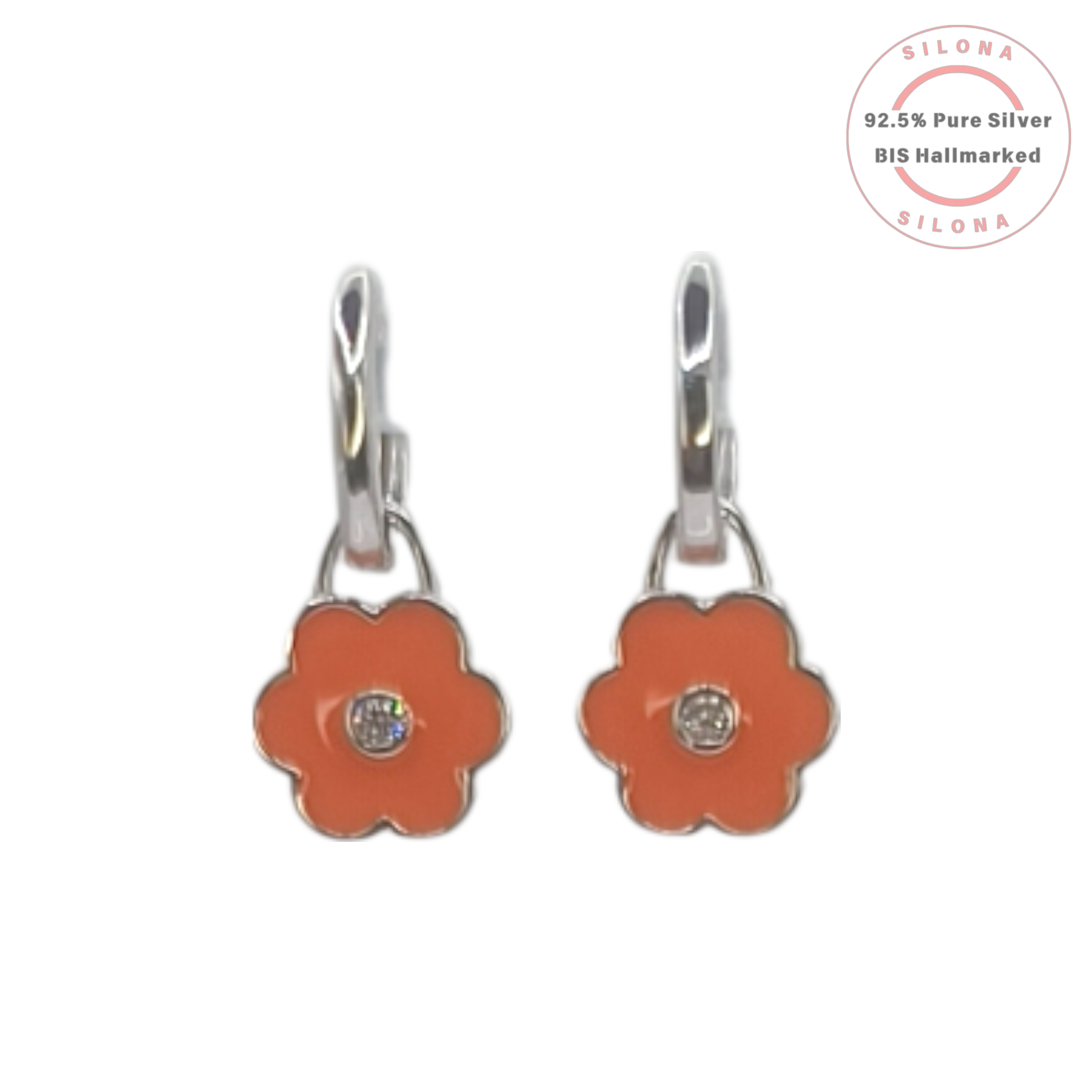 A pair of Silona silver huggie hoop earrings with dangling coral-orange enamel flower charms, each with a central cubic zirconia stone, on a white background.