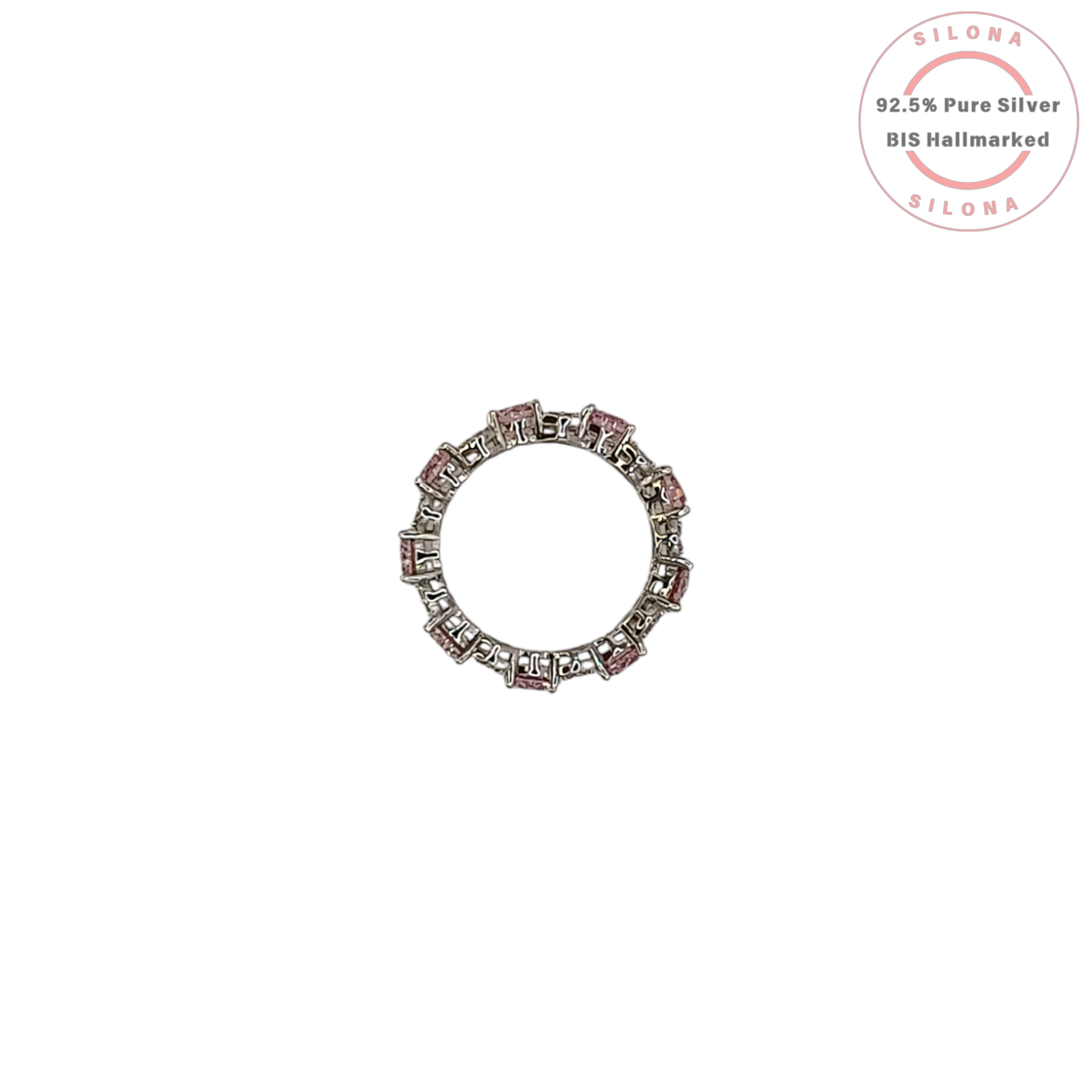 A silver eternity ring featuring large, round, blush pink cubic zirconia stones, interspersed with clusters of small clear pavé stones, on a white background.