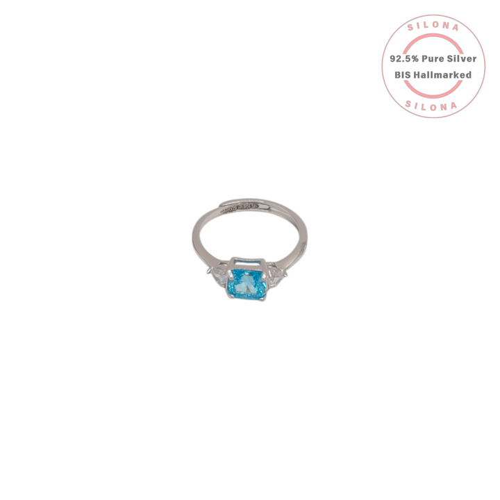 Front view of the Silona Classic Aquamarine Hue Solitaire Ring in 925 silver, showing the central light blue radiant-cut stone and two side stones on a white background.