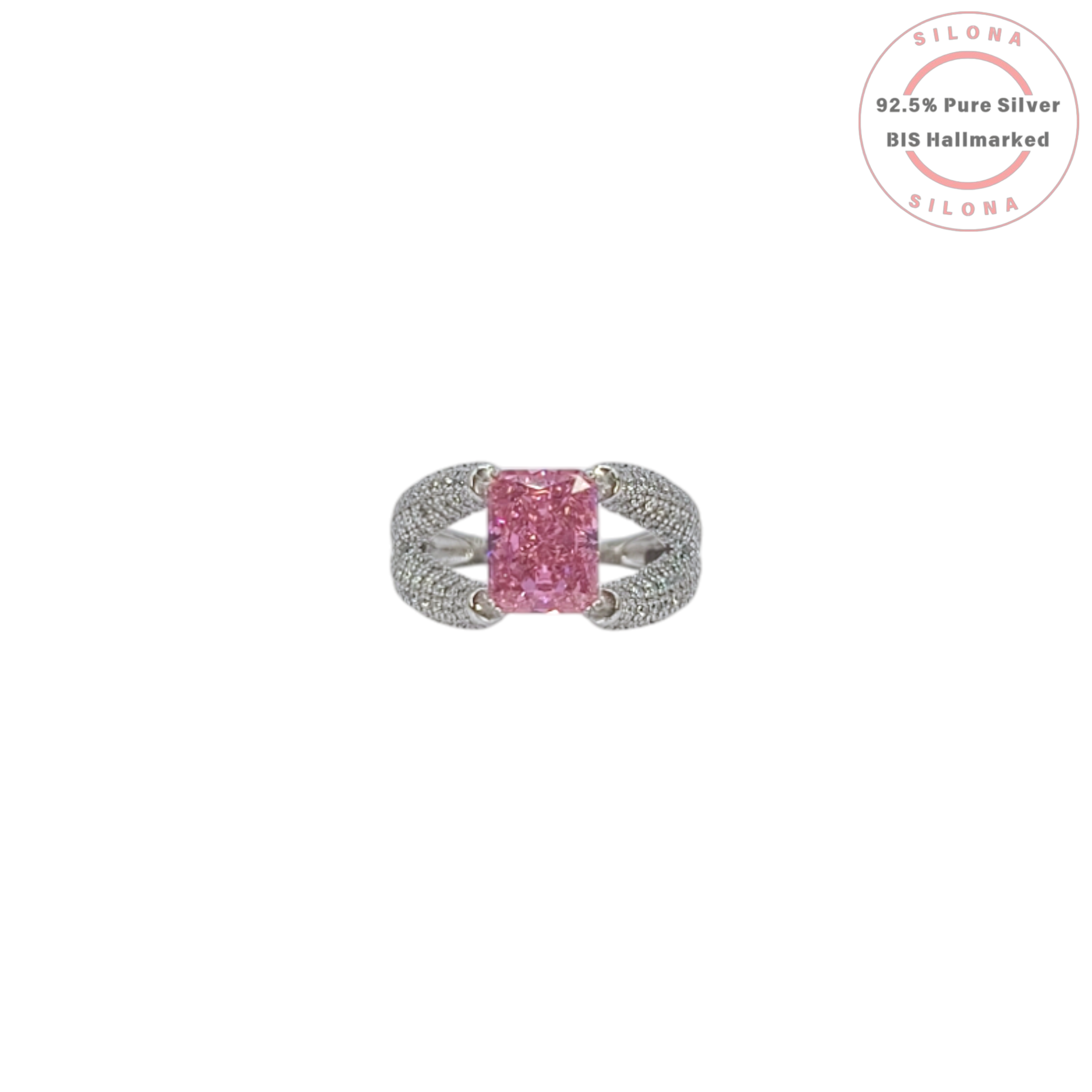 A glamorous statement ring featuring a large, radiant-cut pink cubic zirconia, set on a wide, pavé-encrusted 92.5 silver band.