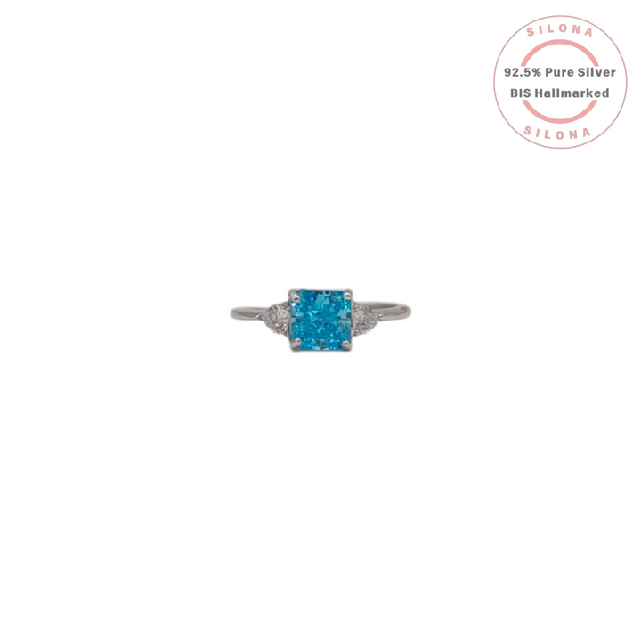 Front view of the Silona Classic Aquamarine Hue Solitaire Ring in 925 silver, showing the central light blue radiant-cut stone and two side stones on a white background.