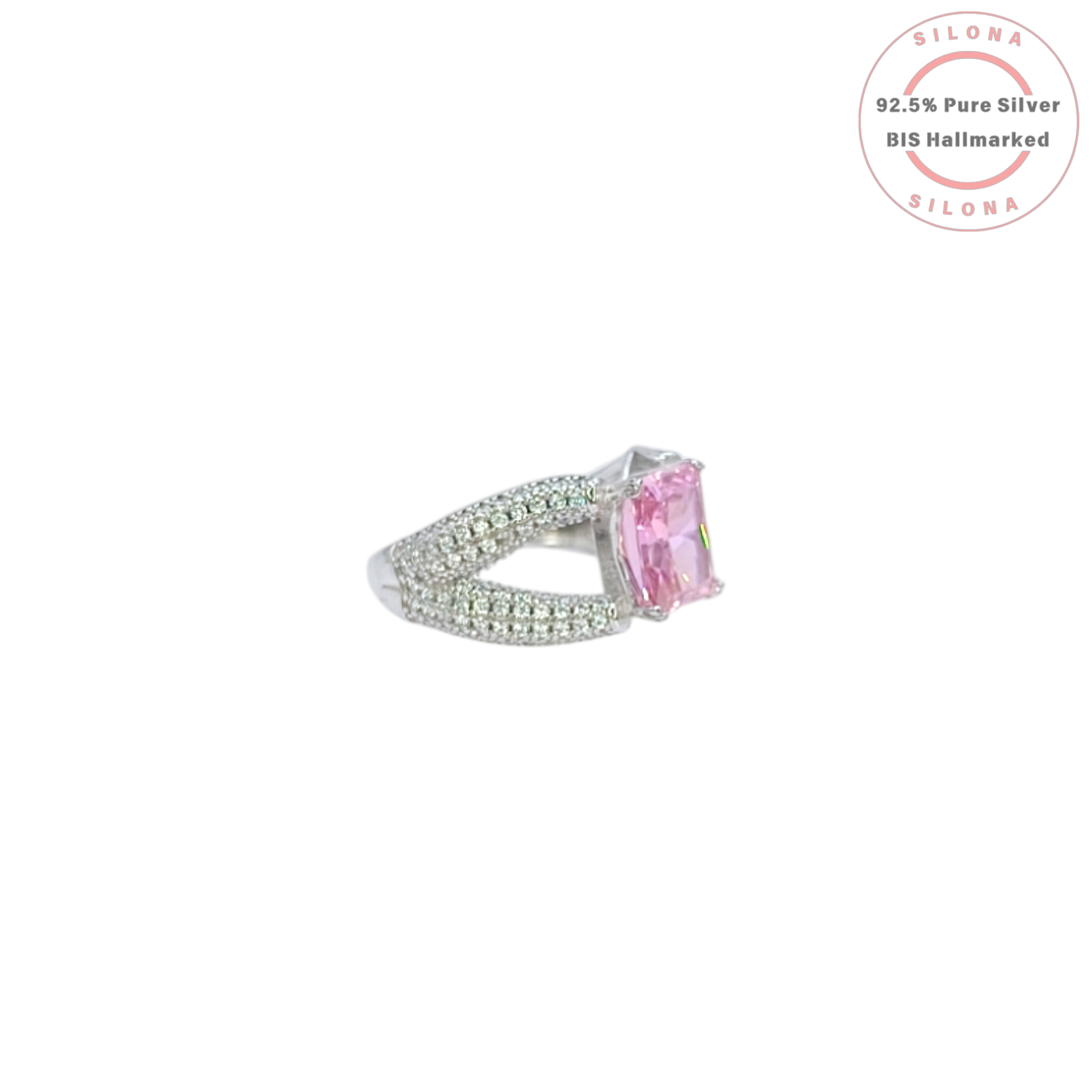 A glamorous statement ring featuring a large, radiant-cut pink cubic zirconia, set on a wide, pavé-encrusted 92.5 silver band.