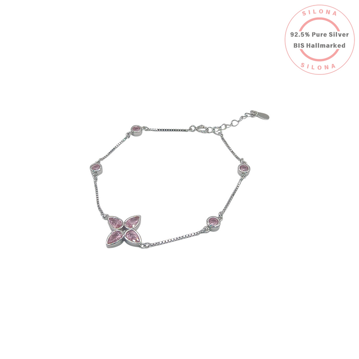 Dainty clover leaf bracelet in 92.5 silver with pear-cut pink cubic zirconia on a white background.