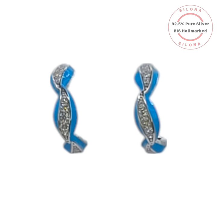 Pair of Silona twist huggie earrings in 92.5 silver, featuring one strand of vibrant blue enamel and another of pavé-set cubic zirconia, on a white background.