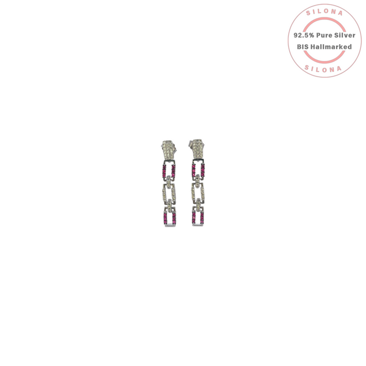 A pair of Silona's modern interlocking link drop earrings in 92.5 silver, featuring pavé-set clear and ruby-hued cubic zirconia stones, on a white background.