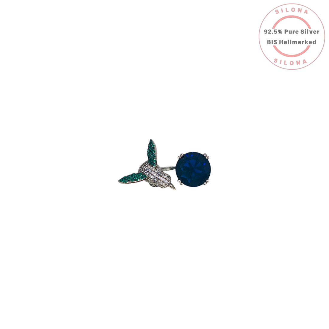 Silona Sculptural Hummingbird Ring in 92.5 silver, featuring a pavé set bird and a large, deep blue faceted stone, on a white background.
