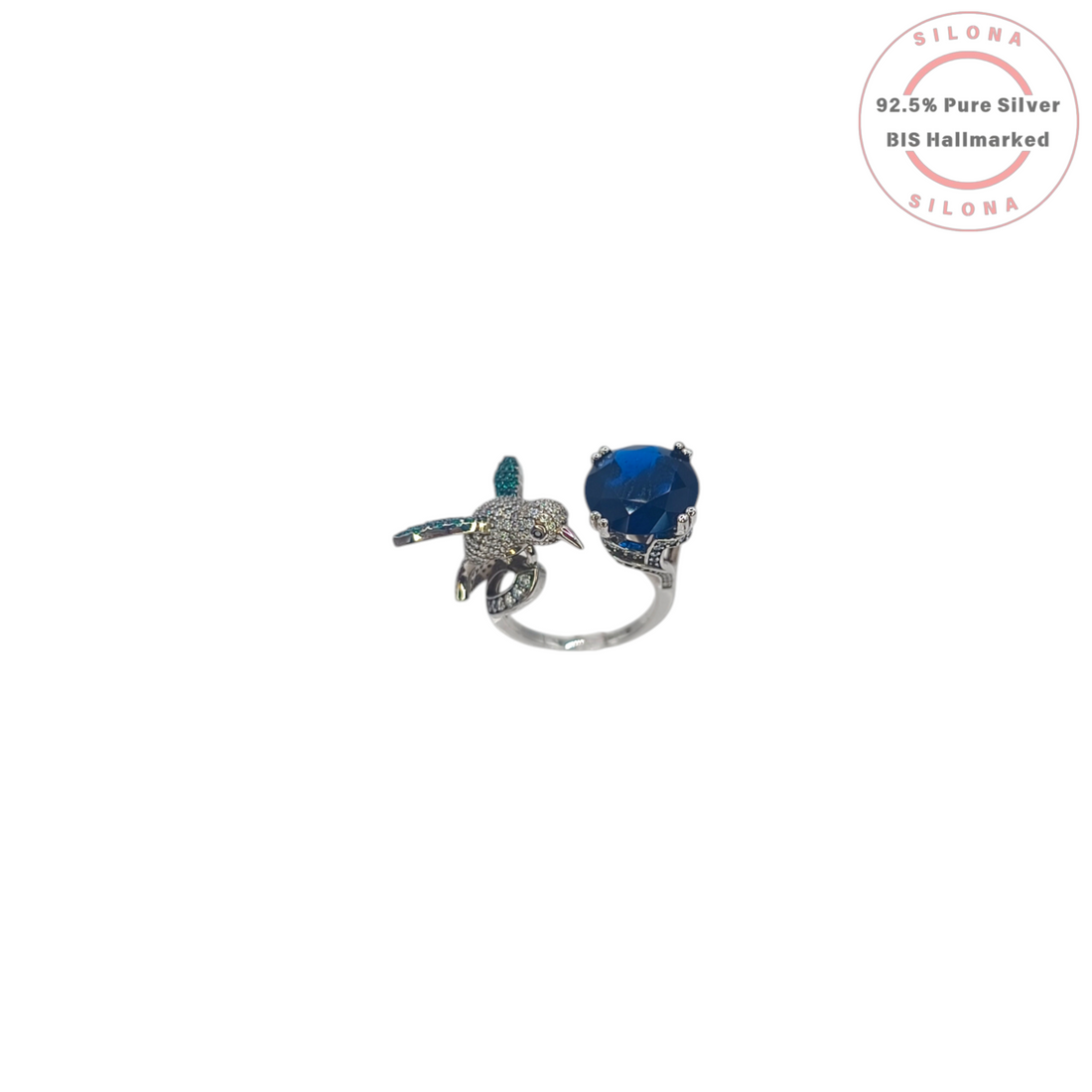 Silona Sculptural Hummingbird Ring in 92.5 silver, featuring a pavé set bird and a large, deep blue faceted stone, on a white background.