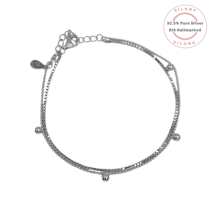 A minimalist dual-chain layered bracelet in pure 92.5 silver, featuring a box chain and a bead chain with small polished sphere accents, on a white background.