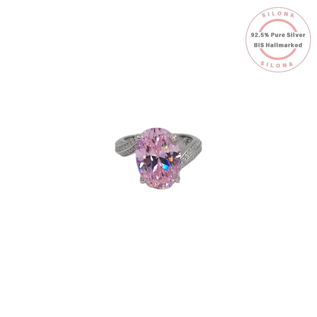 Front view of a statement silver ring featuring a large oval-cut pink cubic zirconia stone with a pavé-set split shank band on a white background.