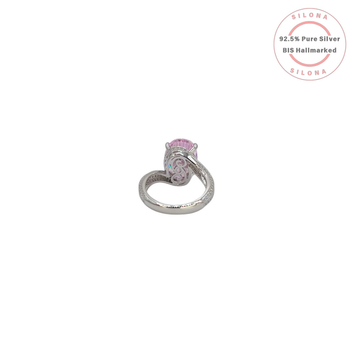 Front view of a statement silver ring featuring a large oval-cut pink cubic zirconia stone with a pavé-set split shank band on a white background.