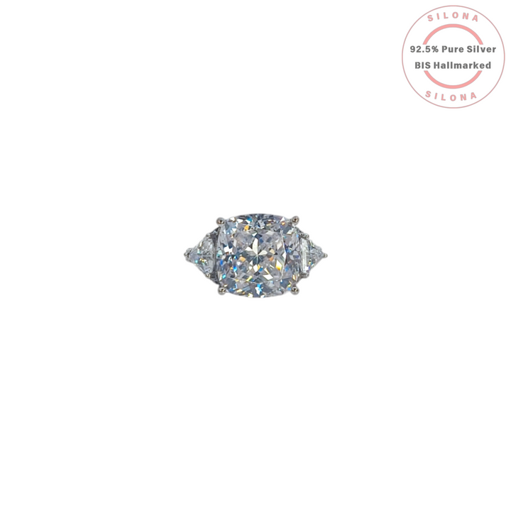 Silona's Classic Cushion Cut Trilogy Ring featuring a large central cubic zirconia stone flanked by two trilliant-cut stones, set in 92.5 hallmarked silver.