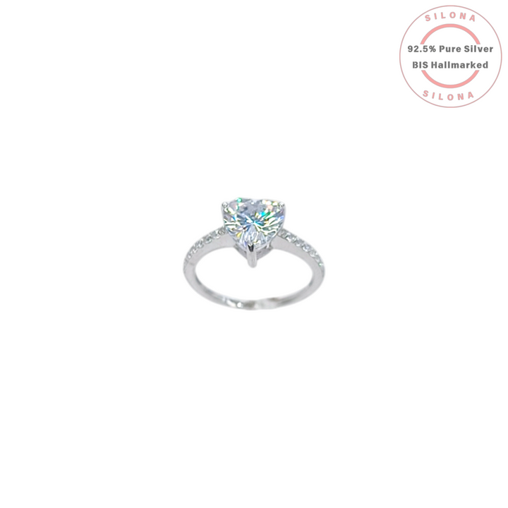 A solitaire heart-cut cubic zirconia ring with a delicate pavé band, crafted in 92.5 sterling silver, photographed on a white background.