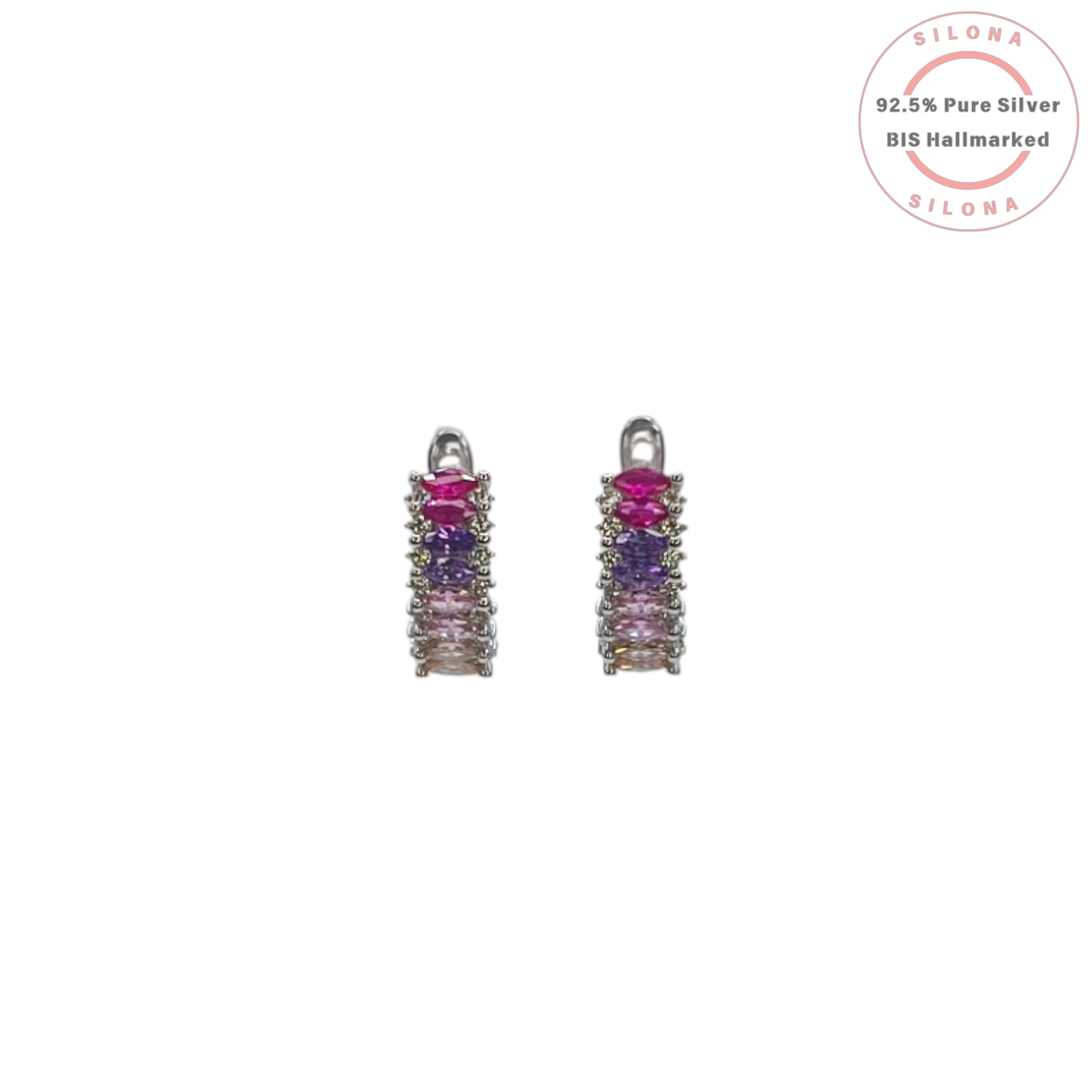 A pair of Silona silver huggie earrings with a vertical gradient of baguette-cut gemstones in shades of pink, purple, and champagne, on a white background.